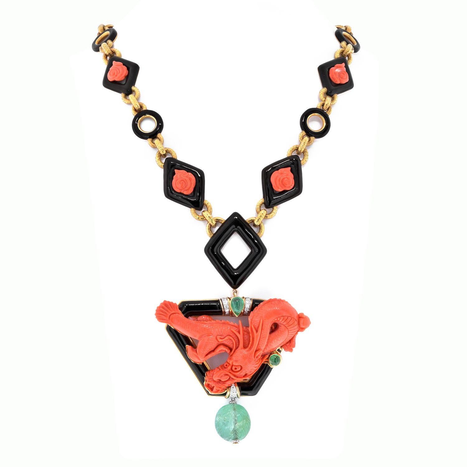 David Webb Platinum & 18K Yellow Gold Coral Dragon Carved Green Emerald Necklace. This is an exceptional coral link style necklace depicting a fierce Dragon. Accented with a large green emerald suspended from a removable pendant. 36 inches long.