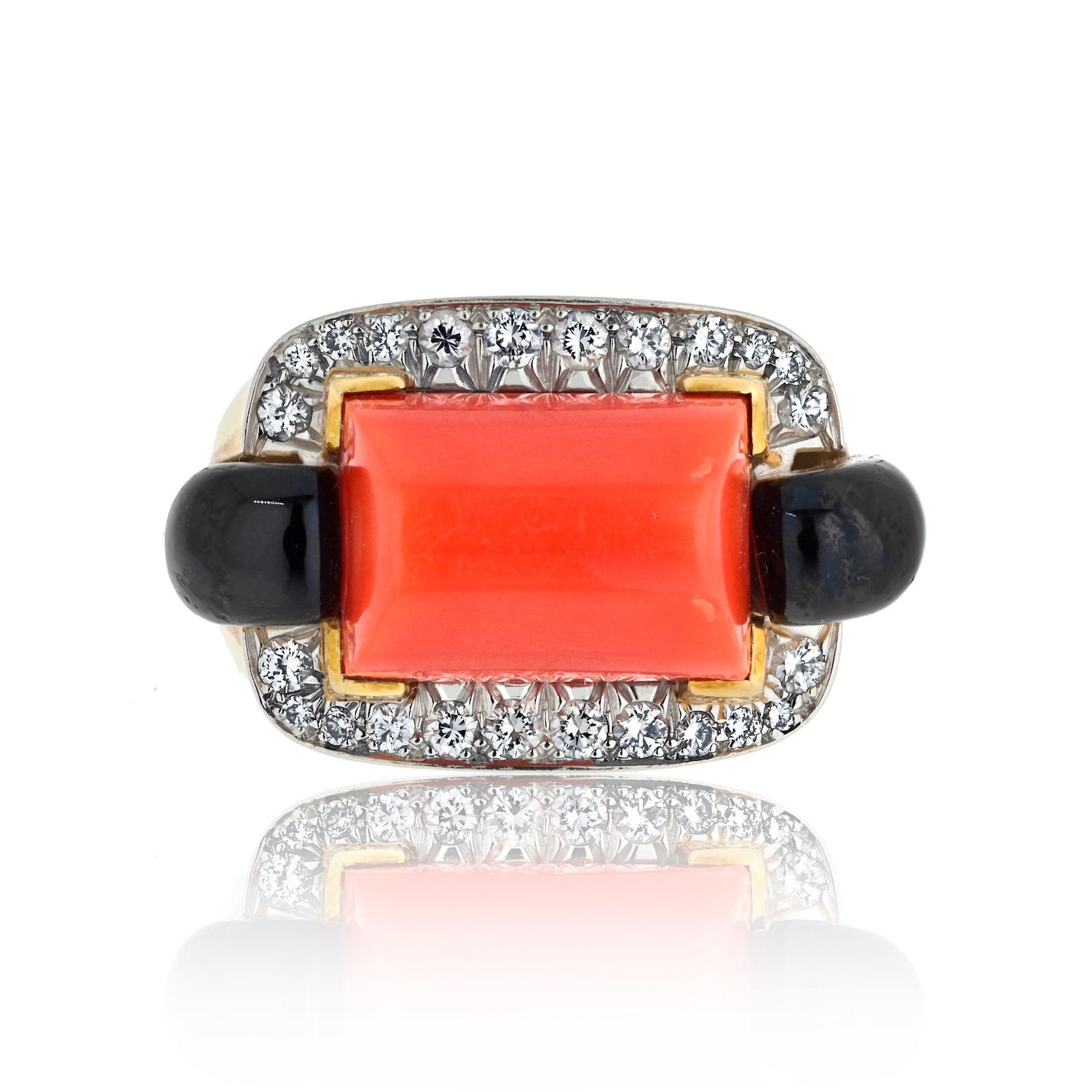 Indulge in the exquisite allure of this David Webb Platinum & 18K Yellow Gold Coral, Onyx, and Diamond Ring. The harmonious blend of vibrant coral and deep onyx creates a captivating contrast, accentuated by the brilliance of diamonds. 

Crafted