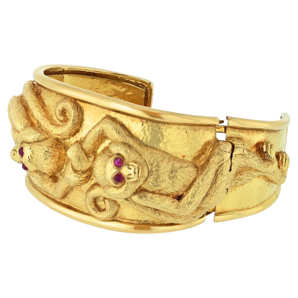 Indulge in the whimsical charm of the David Webb Repoussé Monkey Cuff, a masterfully crafted piece in 18K Yellow Gold that captures the playful spirit of two monkeys holding hands.

**Key Features:**

1. **Material:**
   - Meticulously crafted in