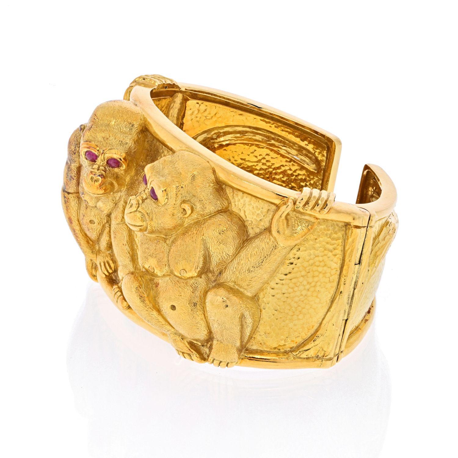 Embrace the playful elegance of the David Webb 18K Yellow Gold Double Monkey Cuff, a signature piece that captures the spirit of the jungle with its charming depiction of two gorillas in a friendly pose.

**Key Features:**

1. **Material:**
   -