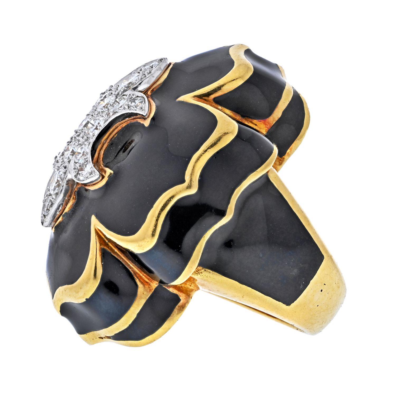 A statement cocktail ring made in 18K Yellow Gold with Fleur de Lis Motif ring by David Webb.
Featuring 0.75 Carats of Round Brilliant Diamonds.
Black Enamel.
Measurements: Band Width 12.7mm, Ornament Width 26.1mm, Ornament Length 32.7mm