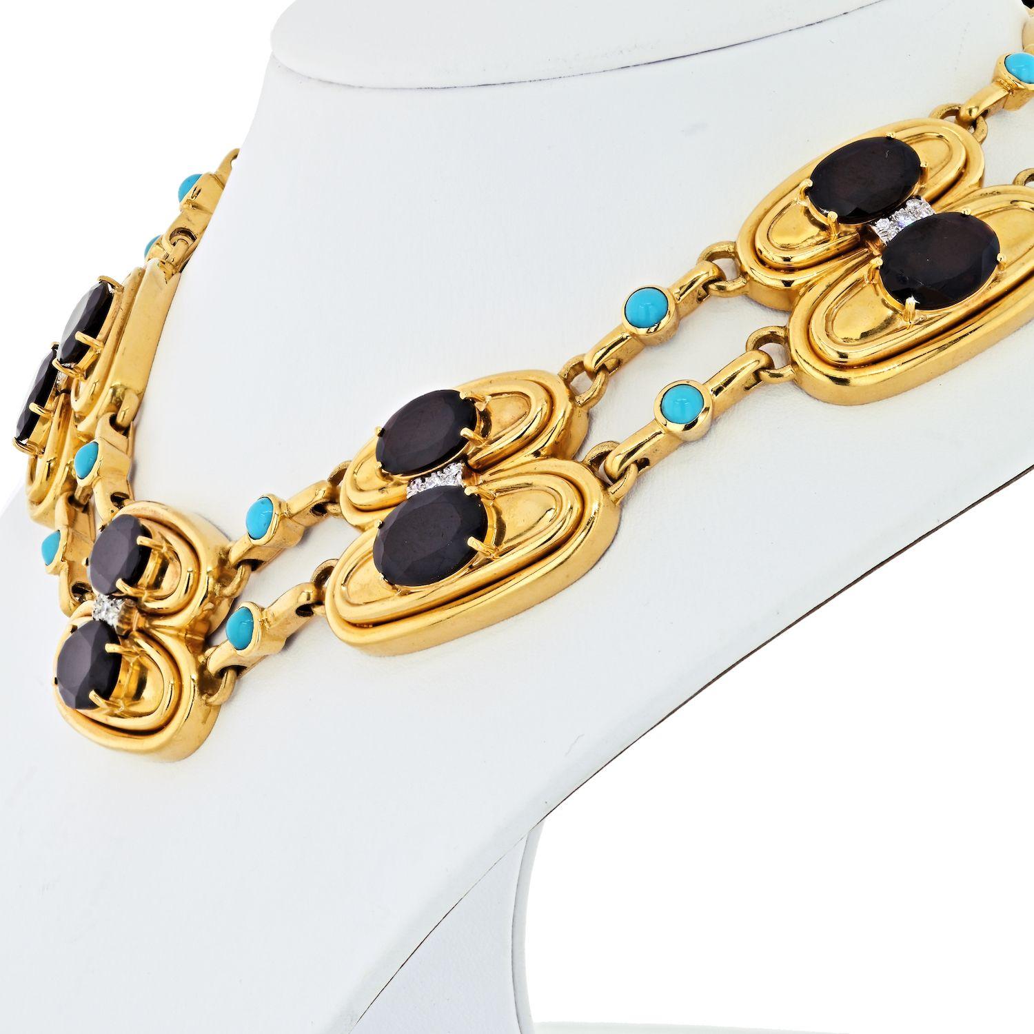 Designed as a two-row band of fluted gold oval twin links each centering upon an oval-cut garnet with circular-cut diamond accents, spaced by gold and cabochon turquoise horsebit links, mounted in 18k gold and platinum. 
This bib style necklace is