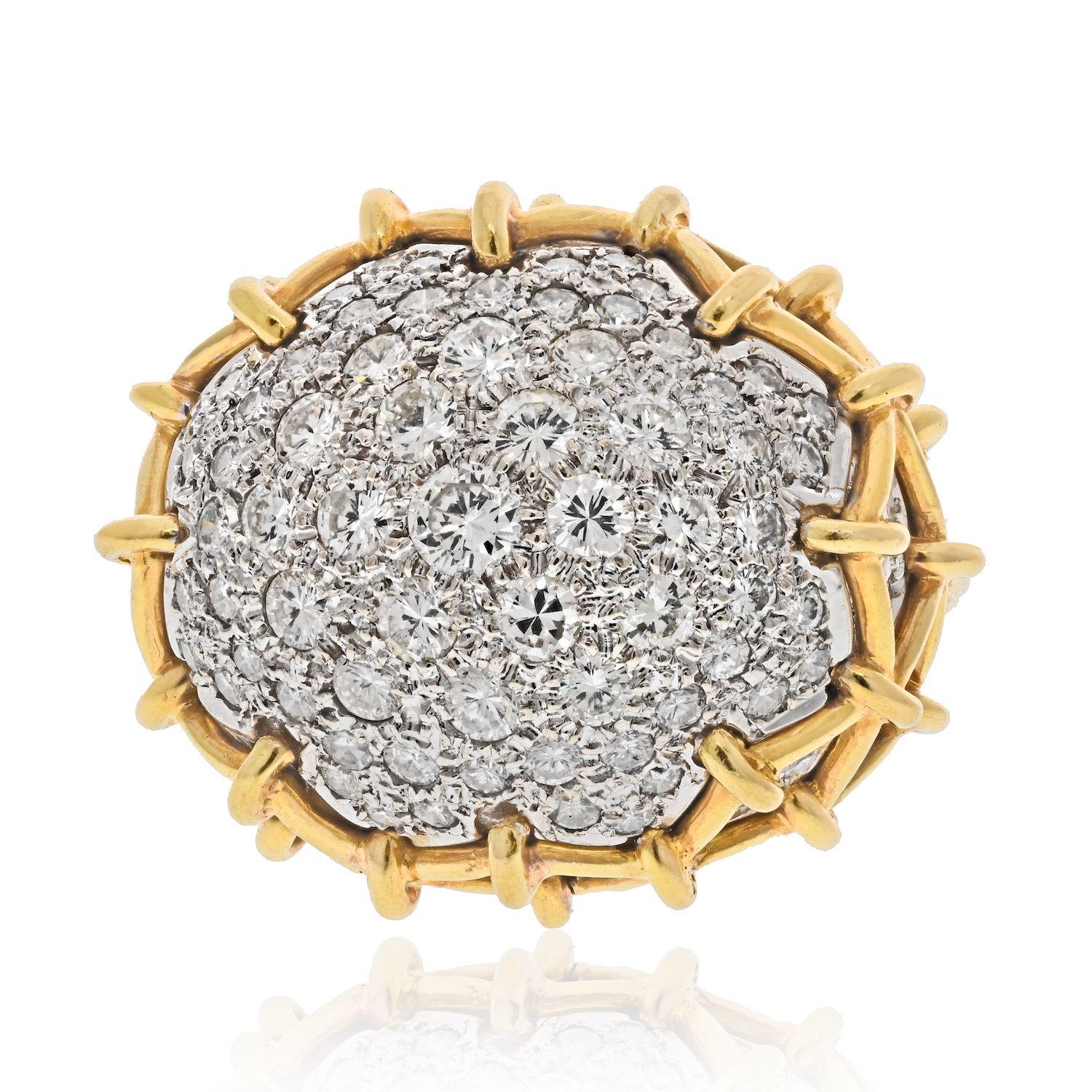A pavé-set, platinum, and 18 karat gold Geodesic Dome diamond ring, by David Webb, first made in c. 1965.
The ring measures a Size 7. It is signed WEBB, stamped 18k, and Plat. The ring has approximately 7 carats in round cut diamonds. 
