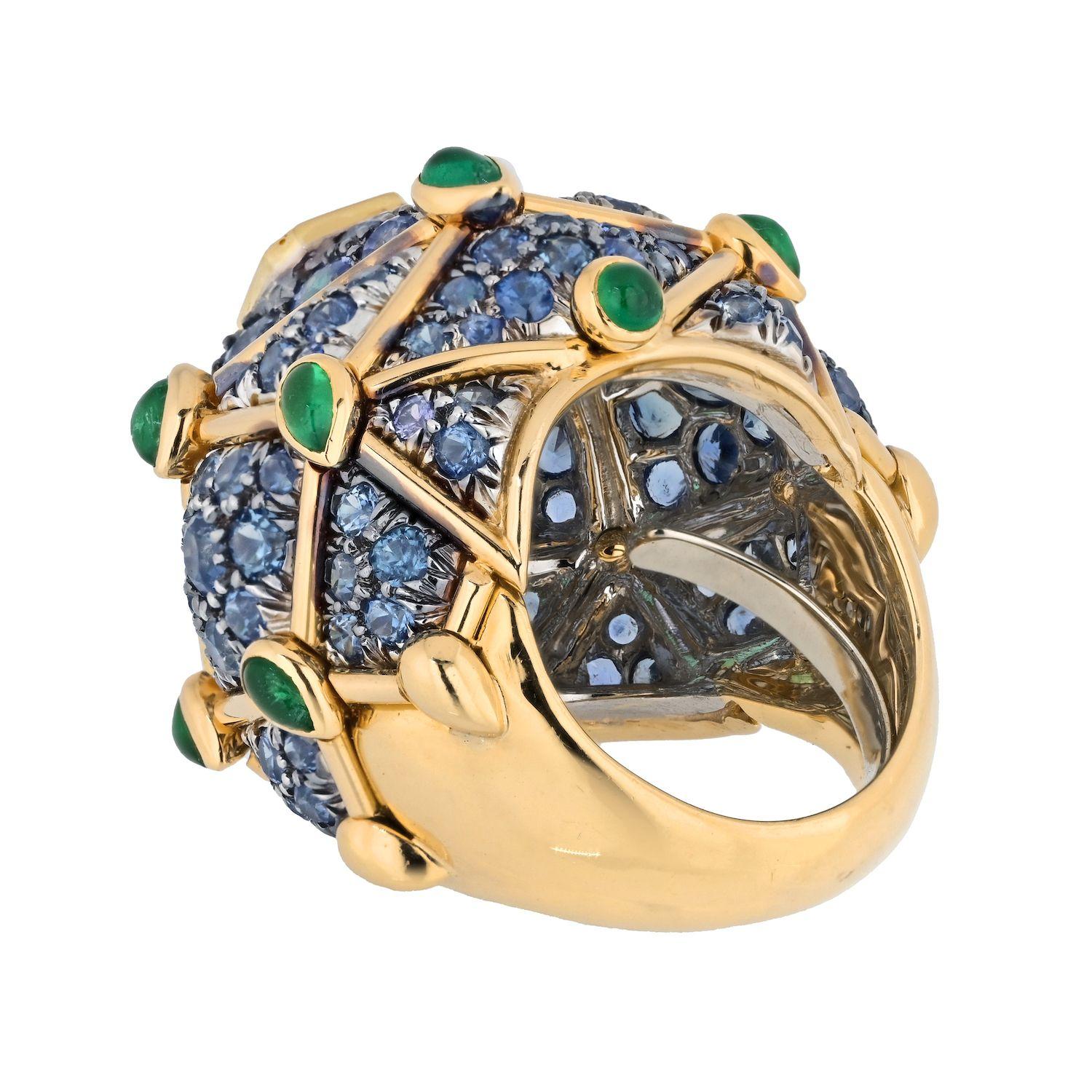 Indulge in the extraordinary with the David Webb Platinum & 18K Yellow Gold Geodesic Dome Emerald and Sapphire Ring. This ring, a true testament to exquisite craftsmanship, combines luxurious materials and intricate design to create a captivating