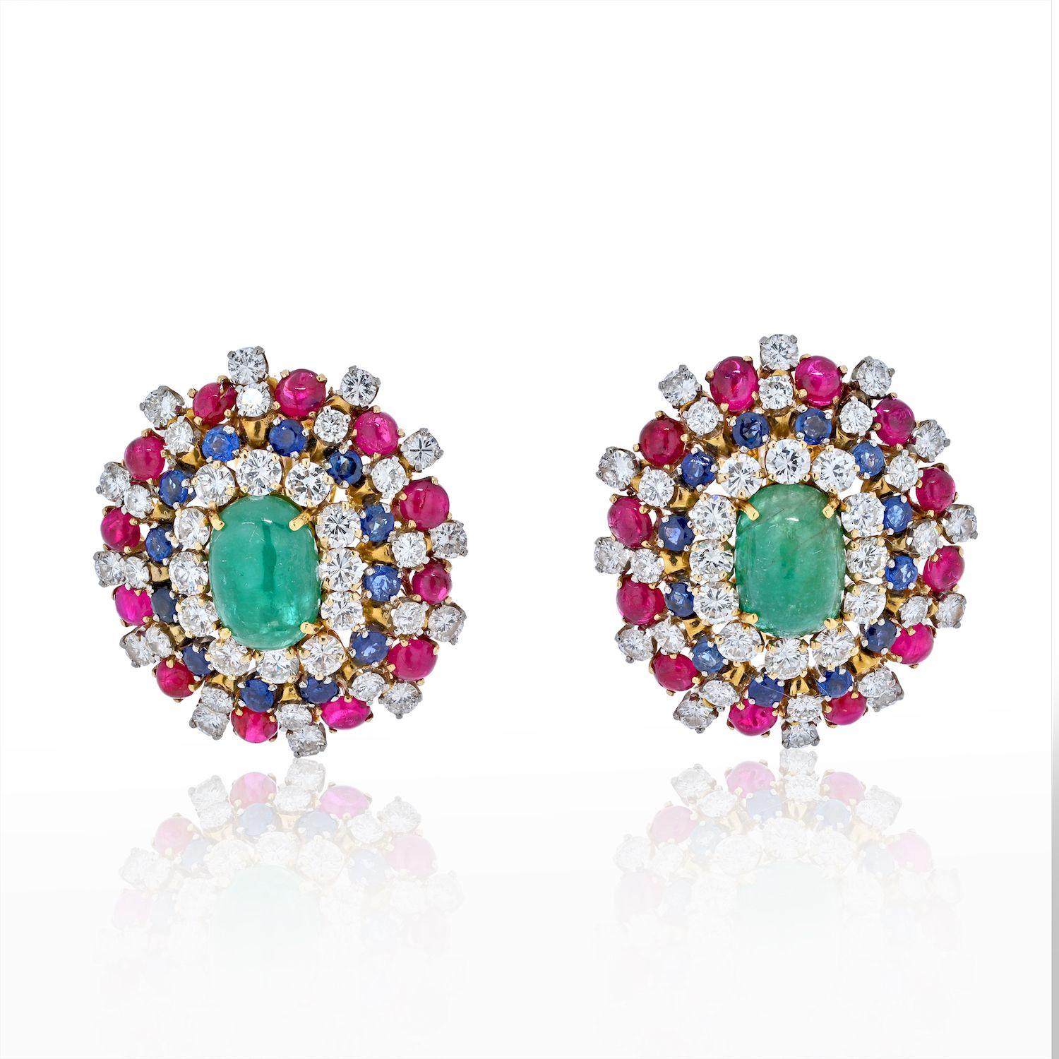 Designed by David Webb these cluster earrings come to us from 1970s. This is a multicolored gemstone domed pair of earrings, each centering acabochon-cut natural emerald surrounded by a smaller tier of round-cut diamonds, sapphires and rubies.