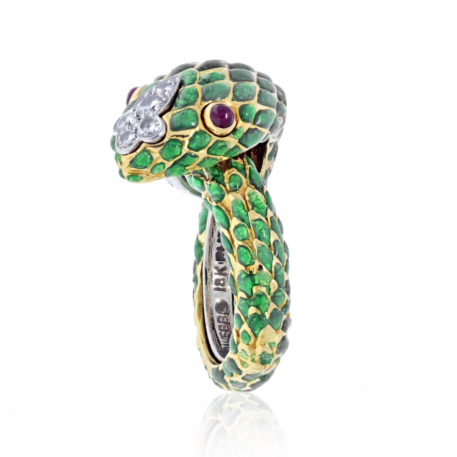 David Webb Platinum & 18K Yellow Gold Green Enamel Ruby Eyes Serpent Ring.
The coiled snake of green enamel and round brilliant-cut diamonds with cabochon ruby eyes
Platinum and 18k yellow gold.
Signed Webb.