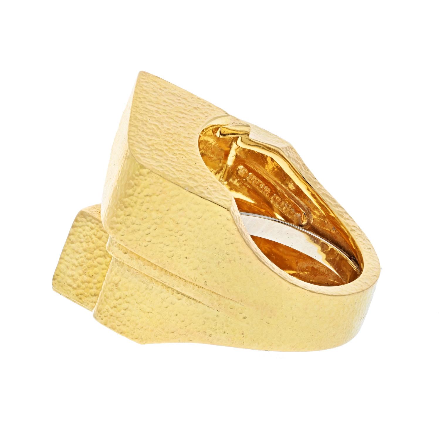 This is an iconic ring called Ski Slope by David Webb. We love the idea of a gold statement ring, no extra bells just a smooth surface with hammered finish. It is clean and striking, but above all this creative gold statement ring is suitable for