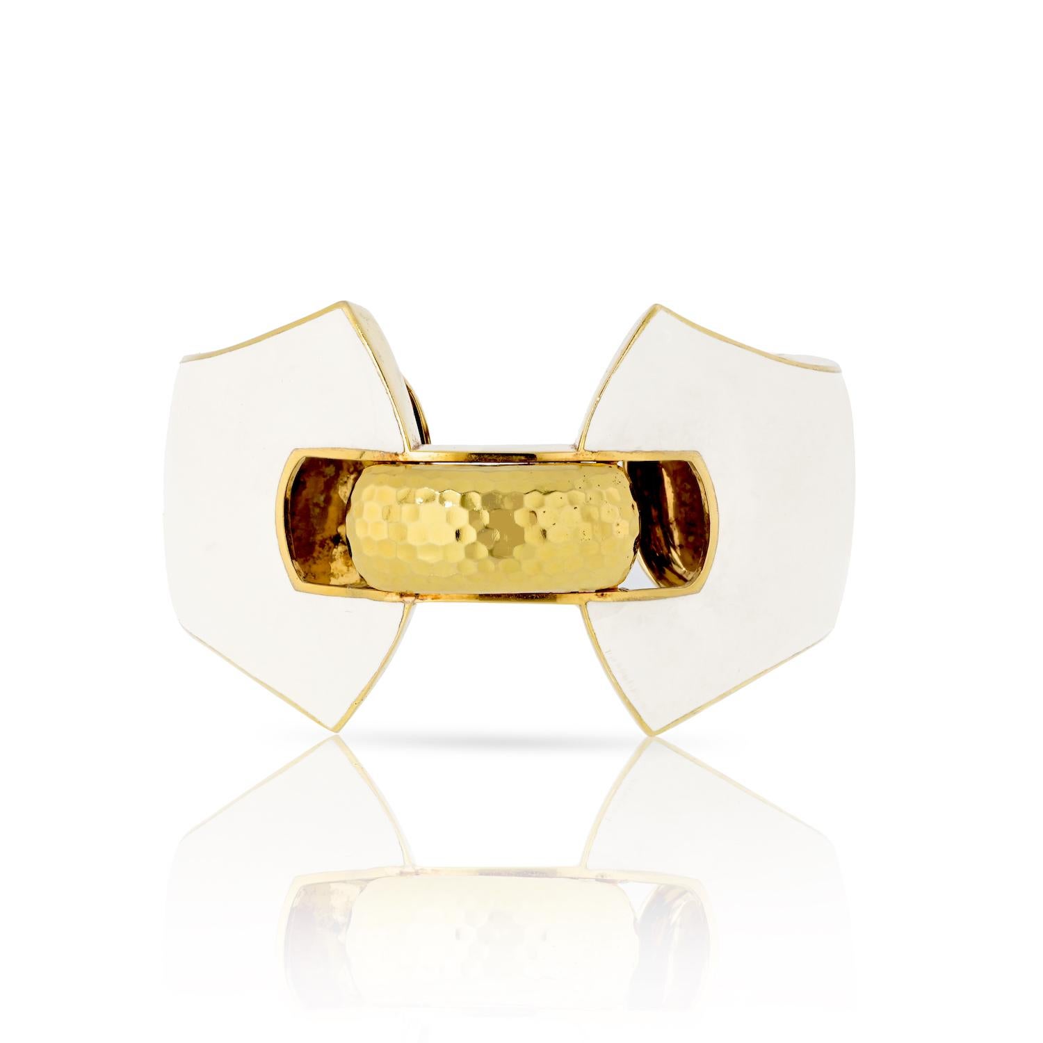 From David Webb's iconic Manhattan Minimalism collection, this exquisite ivory white enamel cuff bracelet is a true work of art. 

Expertly crafted in 18 karat yellow gold. The cuff's unique shape and size make it a statement accessory. 

The inner