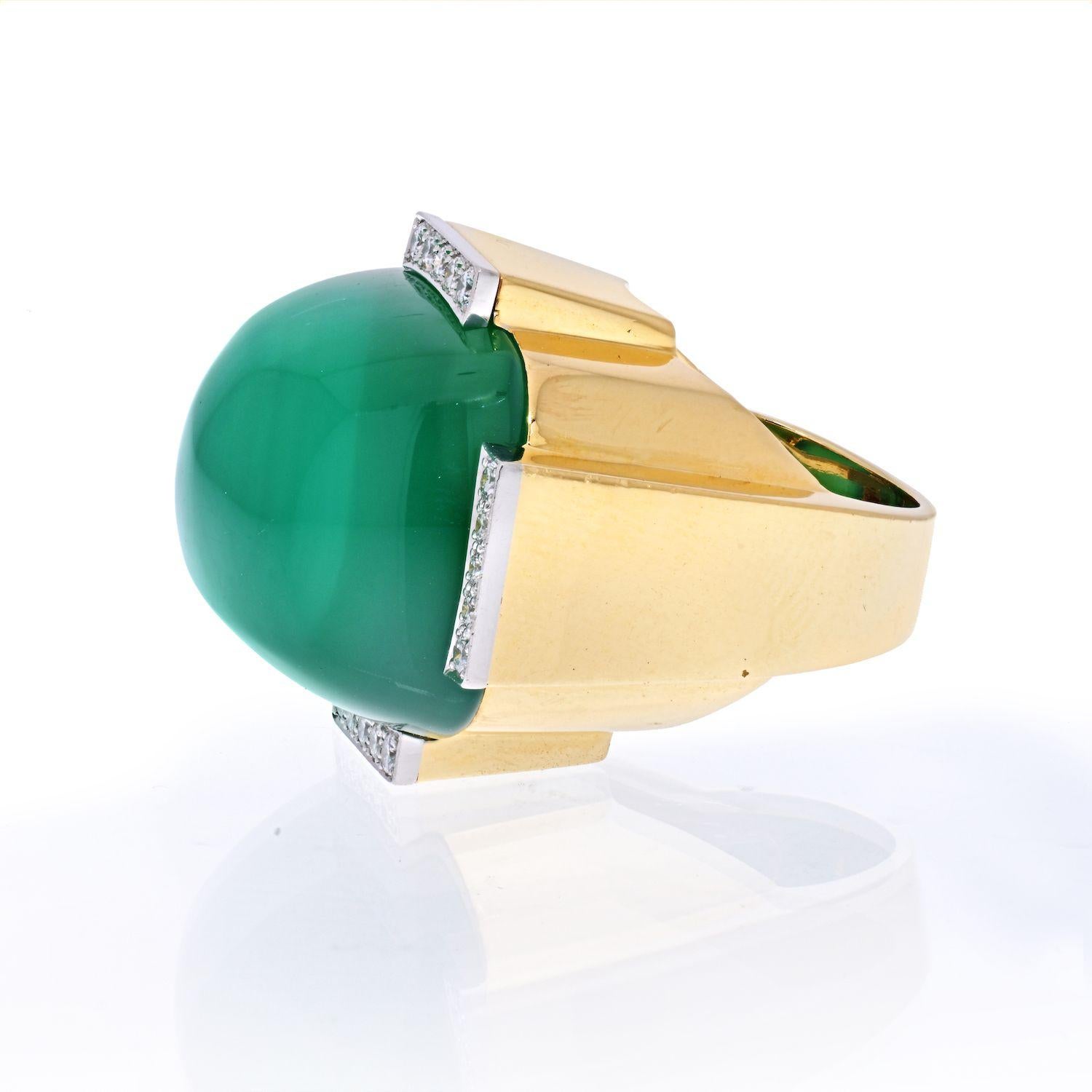 Centering one cushion shape cabochon green onyx weighing approximately 76.00 carats this ring is a stunning representation of the brilliant David Webb. 
There are 20 full cut diamonds [F-G/VS] weighing approximately 0.70 carats total flanking the