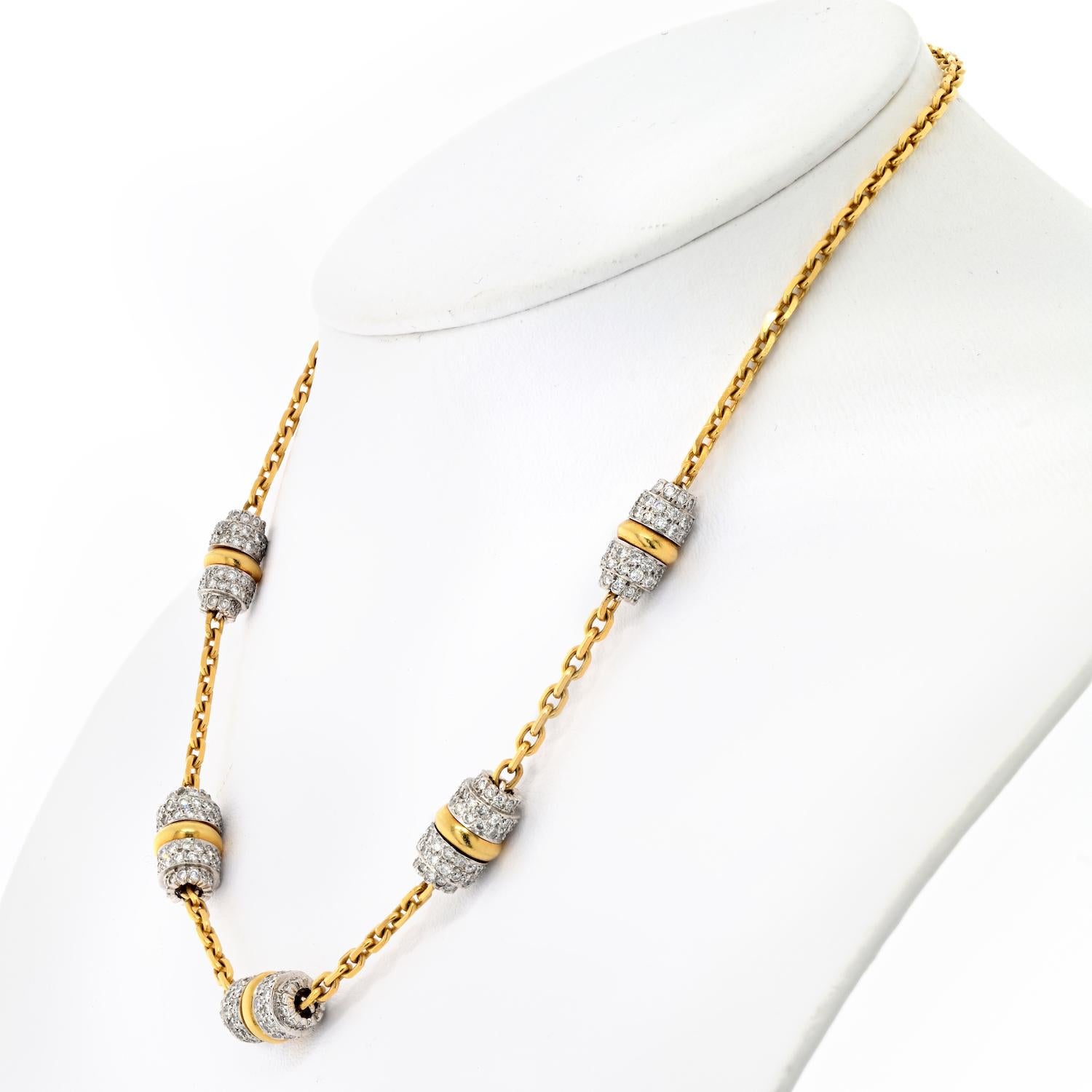 The David Webb 18k Yellow Gold and Platinum Night Cap Chan Necklace is a stunning piece of jewelry that exudes elegance and luxury. This necklace features five 
