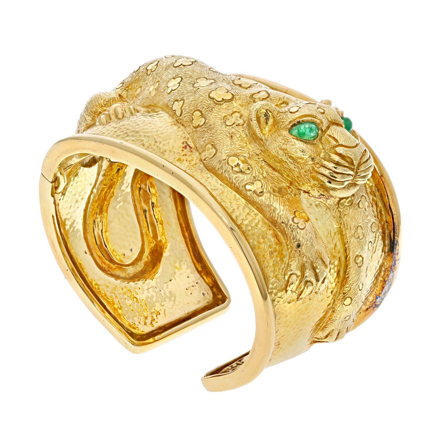 From Kingdom Collection Repoussé Leopard Hinged Cuff Bracelet. Crafted in 18k yellow gold, eyes mounted with grean cabochon pear cut emeralds. 
Hinged lock-clasp; stamped David Webb / Webb 18K. 
Measures 1.75inches wide;
Width: 6.75 in outside