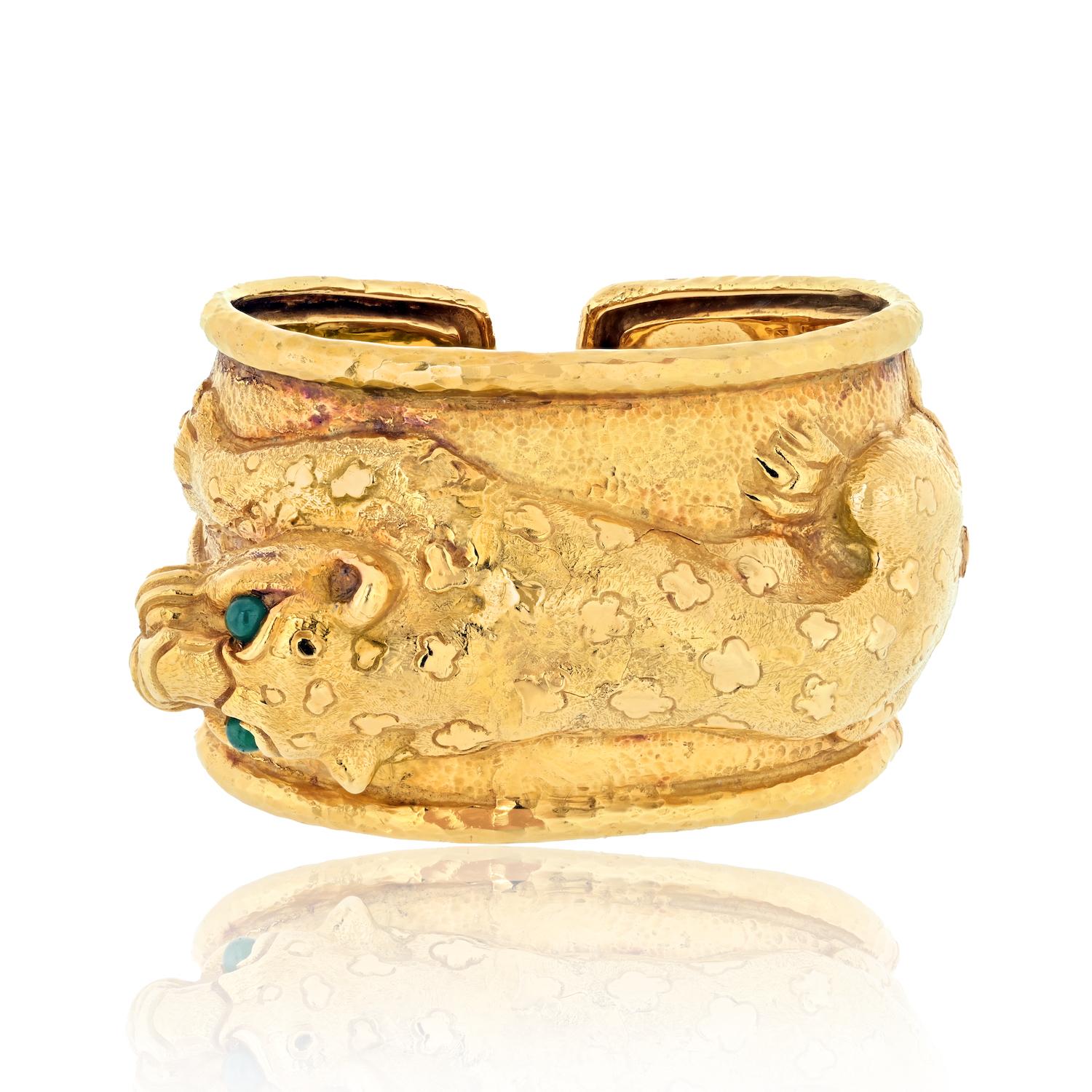 From Kingdom Collection Repoussé Leopard Hinged Cuff Bracelet. Crafted in 18k yellow gold, eyes mounted with grean cabochon pear cut emeralds. 
Hinged lock-clasp; stamped David Webb / Webb 18K. 
Measures 1.75inches wide;
Inside: 6 inches inside