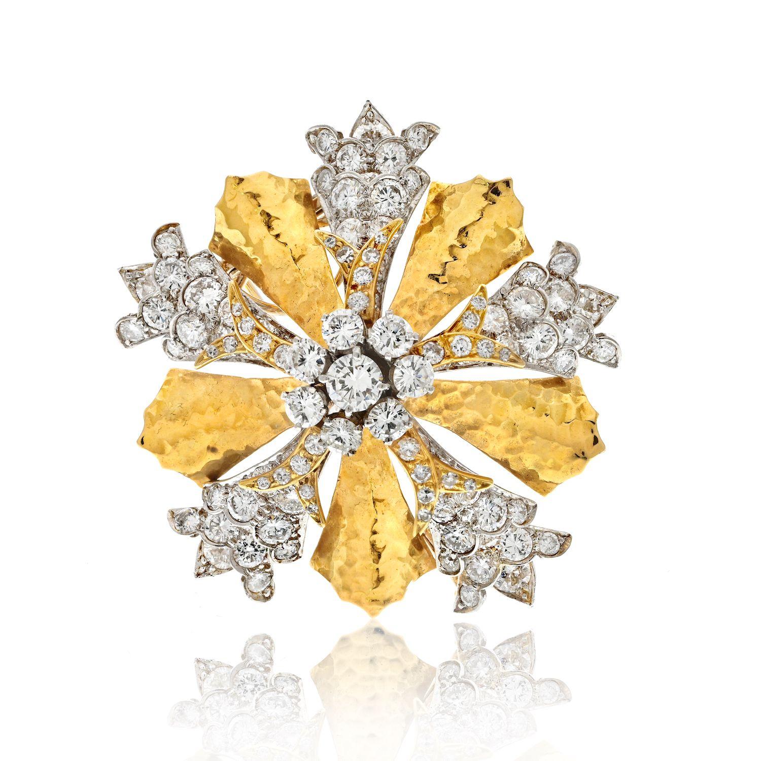 The David Webb Hammered Gold, Platinum, and Diamond Clip-Brooch is a magnificent piece of jewelry, showcasing the exceptional craftsmanship and design for which David Webb is known. Crafted in 18kt gold, this brooch features a stunning floret