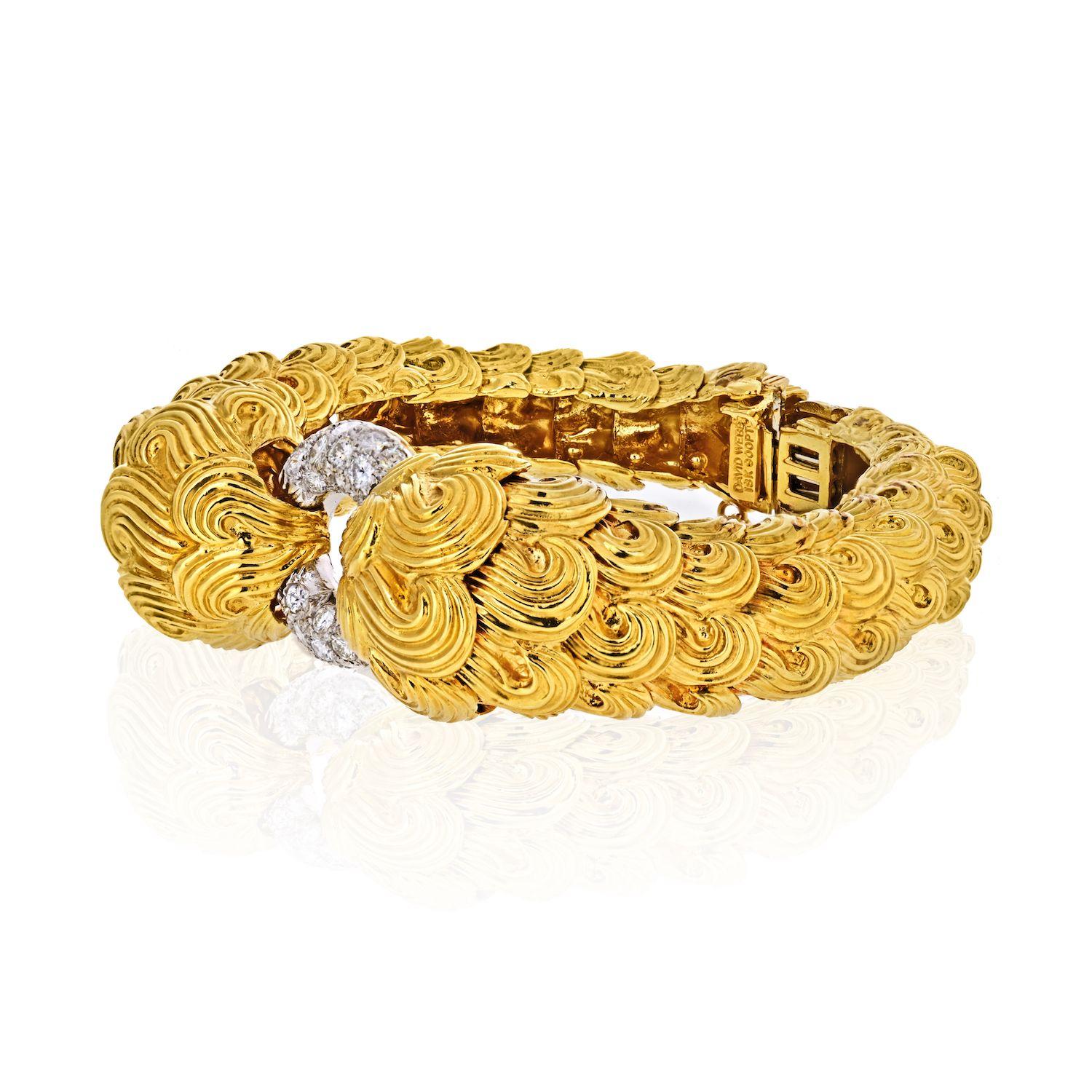 David Webb vintage bracelet designed as a hinged bangle, with two opposing textured gold sides in the 18k scroll textured gold. This bangle joined at the top by a circular-cut diamond hoop, 2 ins. diameter.
