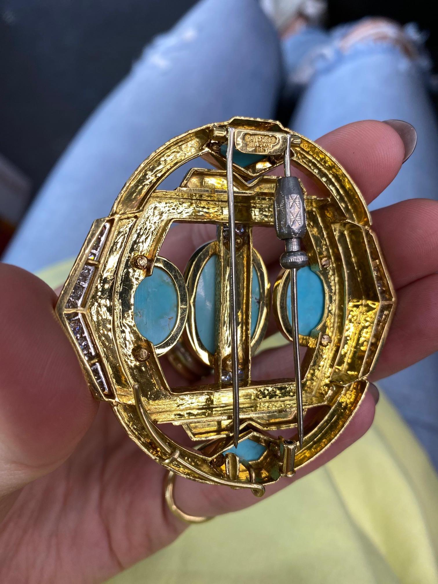 David Webb Platinum & 18K Yellow Gold Turquoise, Diamonds, Hammered Finish Brooch

L: 2.5 inches
W: 2.5 inches at it's widest
Three oval cabochon turquoise.
Two shield cut cabochon turquoises.
Round Cut diaonds: approx 1.50cts.
Double pin closure.