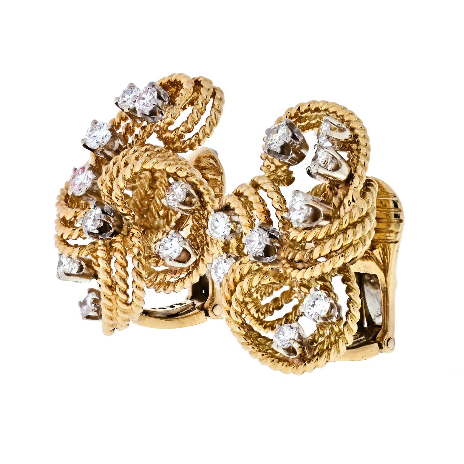 Elegant gold and diamond ear clips by David Webb. Each earring has 18 diamonds with a total weight of approximately 2.00 carats. They are surrounded by rows of twisted gold in a graceful, uplifting design.
Clip backs can be converted to posts.