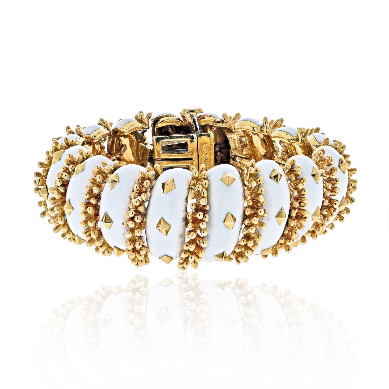 Articulated white enamel and gold accented flexible bracelet by David Webb. Lustrous white enamel alternates with 18K yellow gold this bracelet is artfully decorated with gold accents all throughout. 
Make this your go to bracelet when you are out