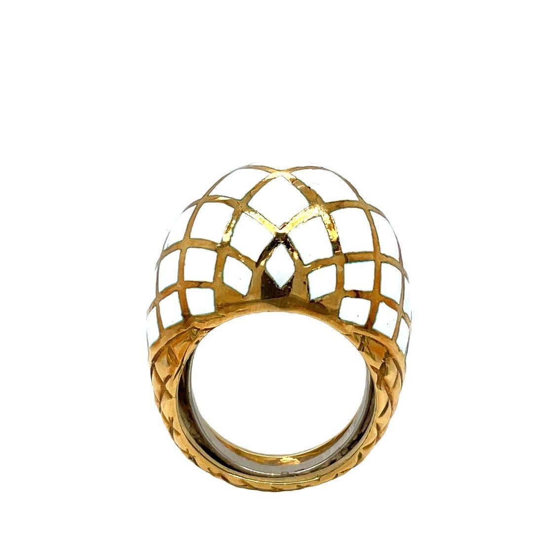 Embrace timeless allure with the classic David Webb bombe ring.  Its high dome shape adds a touch of drama, making it a true statement piece. Crafted from platinum and 18K yellow gold it boasts a captivating white enamel checkerboard pattern on its