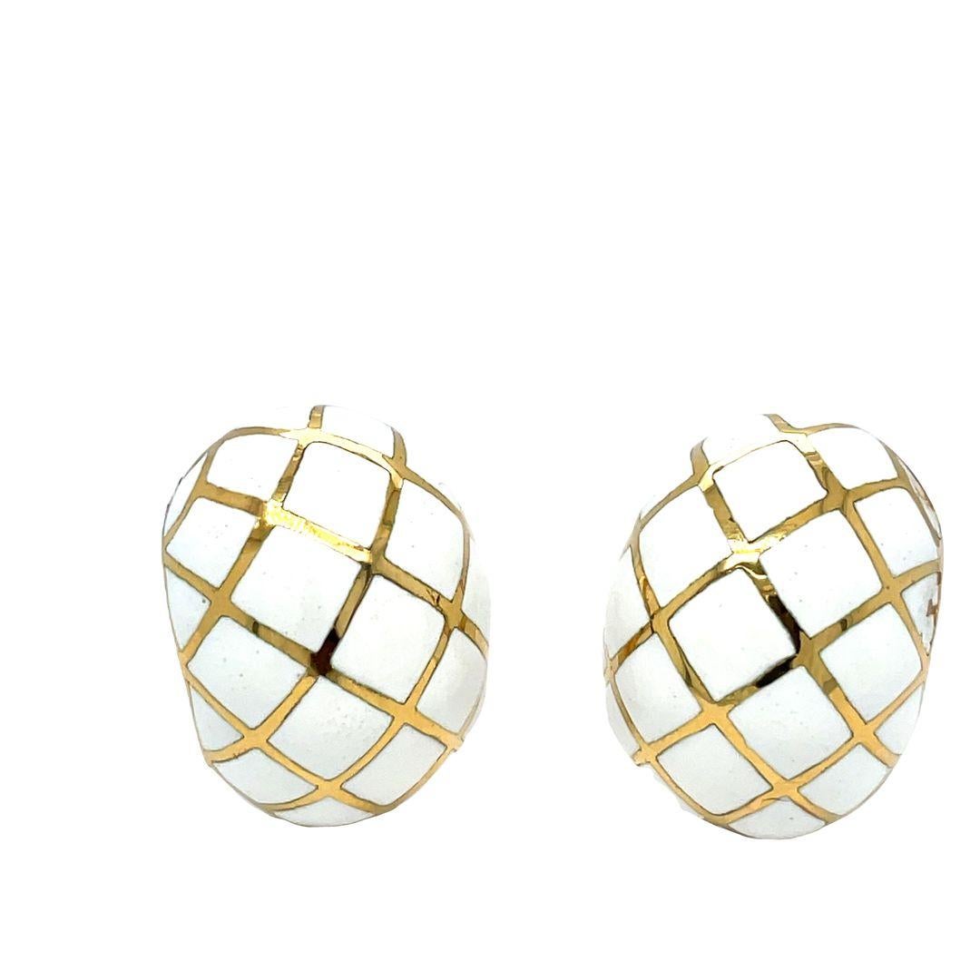 Elevate your style with the classic David Webb bombe earrings. Their dramatic high dome shape creates a true statement piece. Crafted from platinum and 18K yellow gold, these earrings feature a captivating white enamel checkerboard pattern, adding