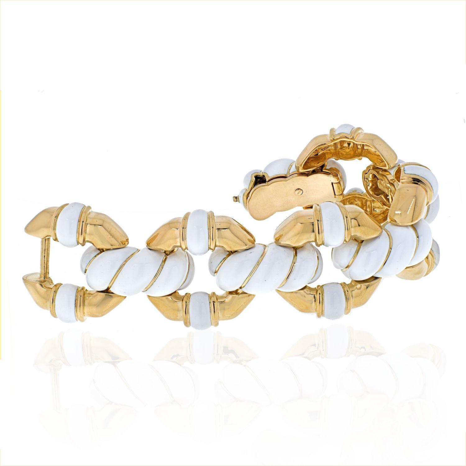 Summer glow looks good on you! This is one lovely fluted white enamel and gold link bracelet crafted in 18K yellow gold by an American designer David Webb which we feel looks great on during the summer months. Heavy to the feel you will know it's an