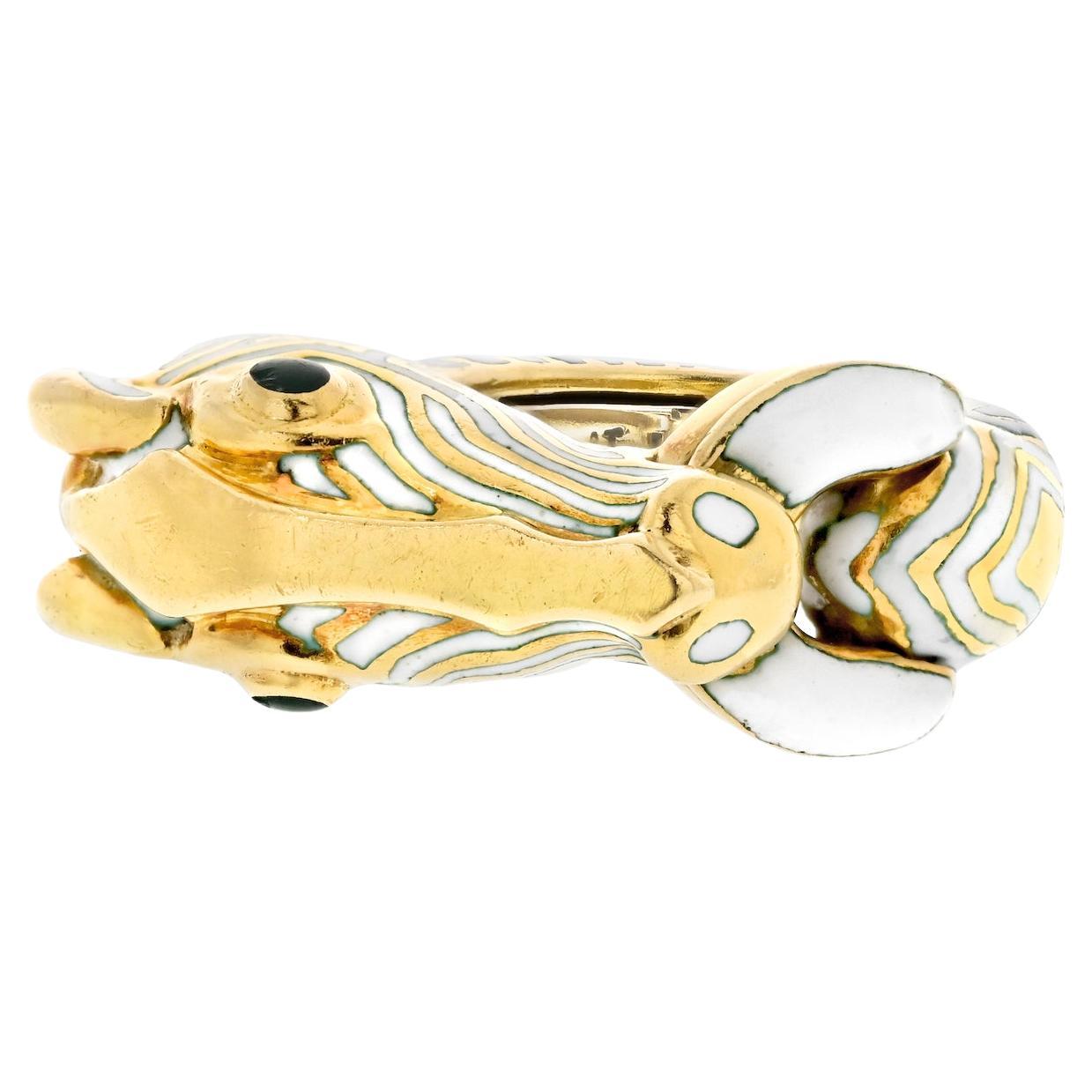 Embrace the wild side of fashion with this captivating estate ring by David Webb. Crafted in the shape of a white zebra with mesmerizing green eyes, this piece is a testament to Webb's creativity and attention to detail. With a ring size of 6, it's