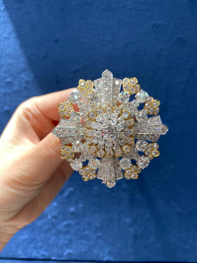 Of particular interest and rarity this David Webb mid-century floral
brooch enhanced old-cut diamonds mounted moustly in Platinum with just a few yellow gold petal accents. Total carat weight: 40 carats (approx.). 
Circa 1950. Width: 2 inches
