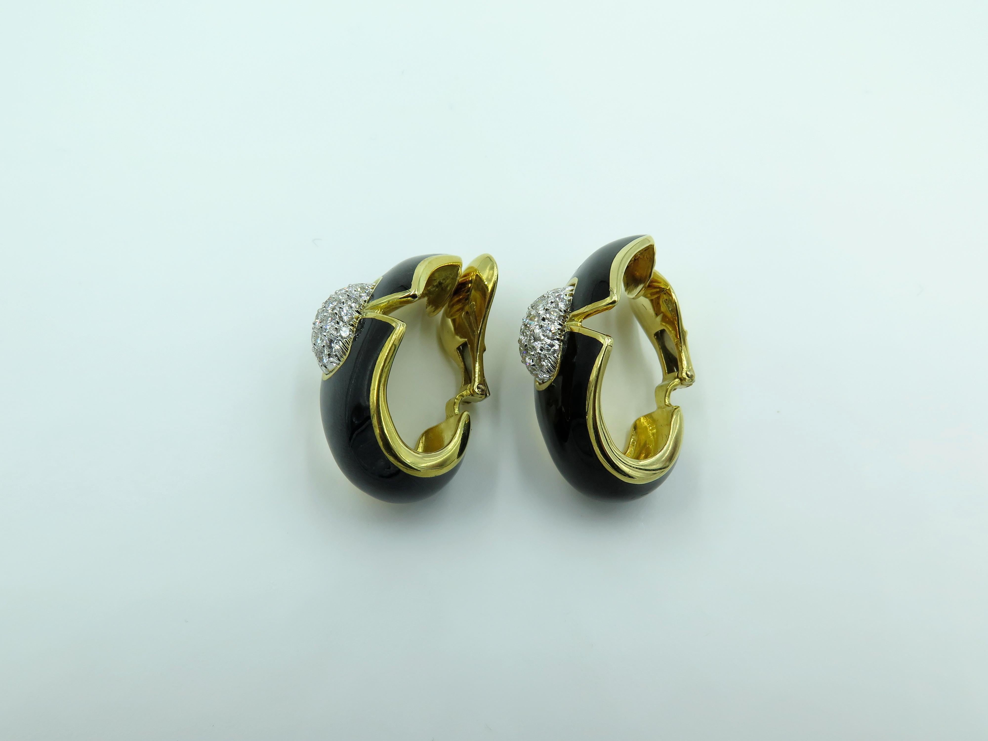 A pair of 18 karat yellow gold, platinum black enamel and diamond Princess Lilian earrings. David Webb. Designed as a sculpted black enamel plaque, centering upon a pavé-set diamond rectangular bombé panel. Forty eight (48) diamonds weigh