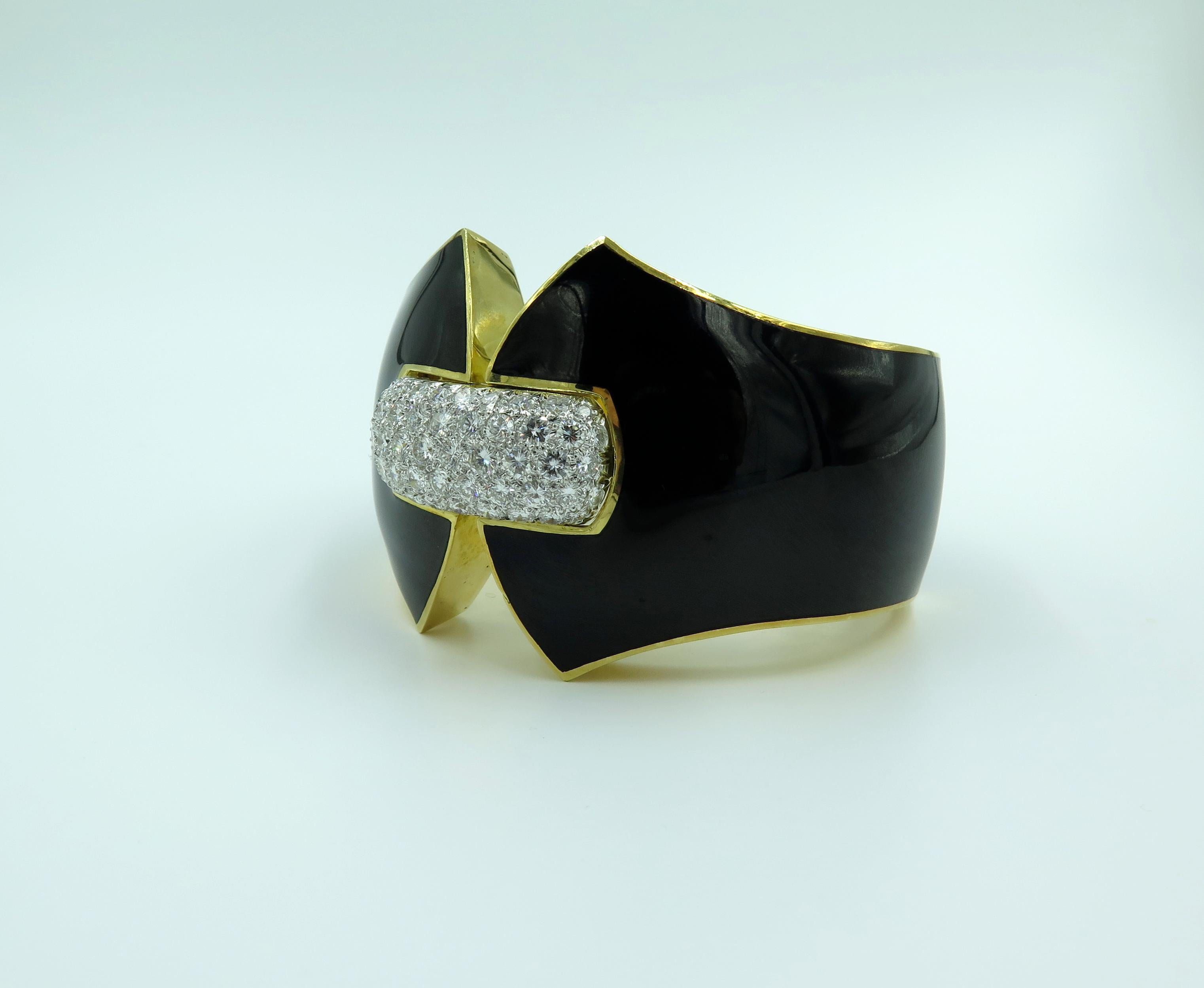 An 18 karat yellow gold, platinum black enamel and diamond Princess Lilian bracelet. David Webb. Designed as a sculpted black enamel hinged cuff, centering upon a pavé-set diamond rectangular bombé panel. Sixty six (66) diamonds weigh approximately