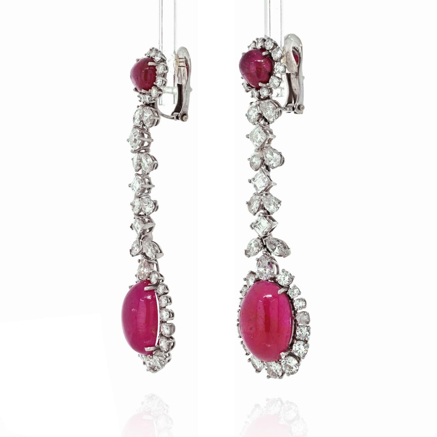 David Webb gem-set drop earrings, each featuring two oval and round cabochon ruby with a prong set round, old-mine and old-European diamond surround, suspended from a diamond-set foliate motif chain, in platinum. 
Length: 2.75 inches. 
Clip closure.