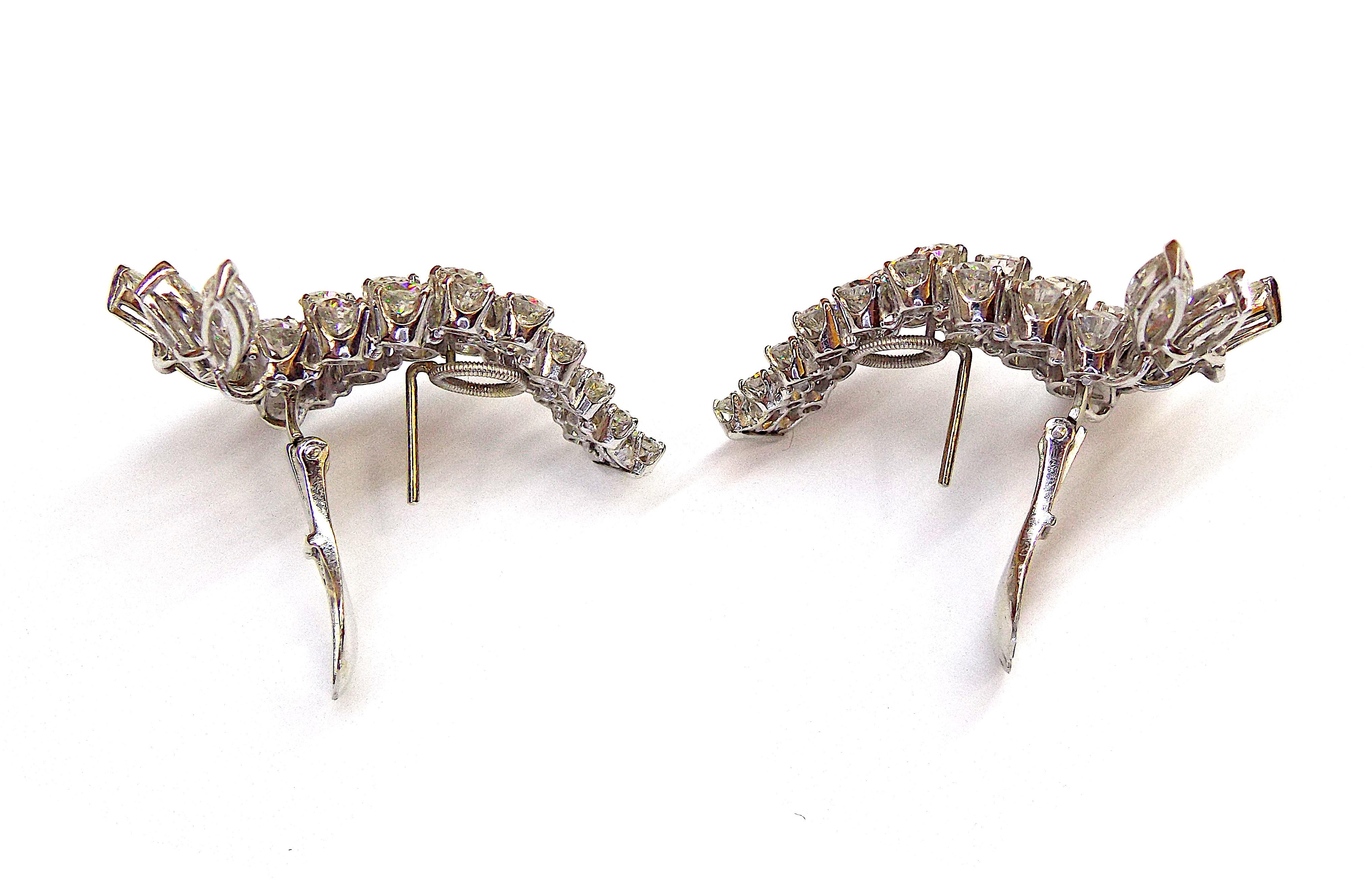 David Webb platinum diamond earrings. Total diamond weight is approximately 14.38ct. Length is approximately 1 5/8 inches. Gross weight is approximately 24.4 grams. Signed Webb. The earrings are designed for pierced ears.