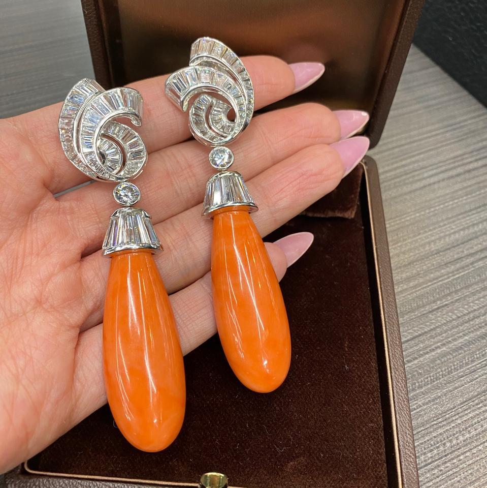 Each suspending a smooth coral drop, from a platinum cap, accented by baguette-cut diamonds these gorgeous David Webb earrings are absolutely stunning. Earrings are 3.4 inches long, the coral drop is detachable. Clip-on backs.

Diamonds: Baguette