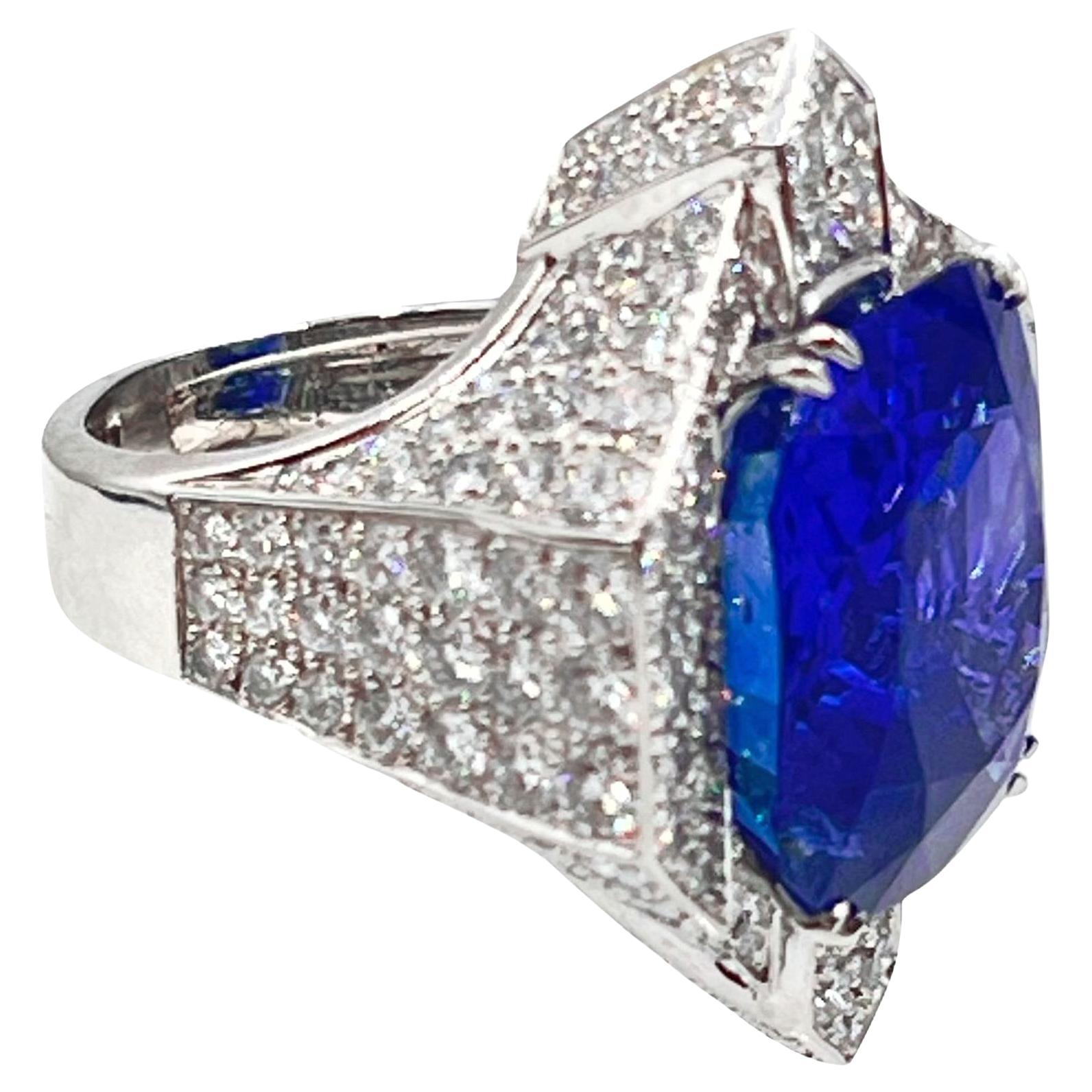 Exquisite platinum, 18 karat white gold, blue sapphire, and diamond ring by David Webb.  The geometric block design mounting is central set with an impressive natural unheated sapphire weighing 38.00 carats.  Vivid blue color. Pave' set with one