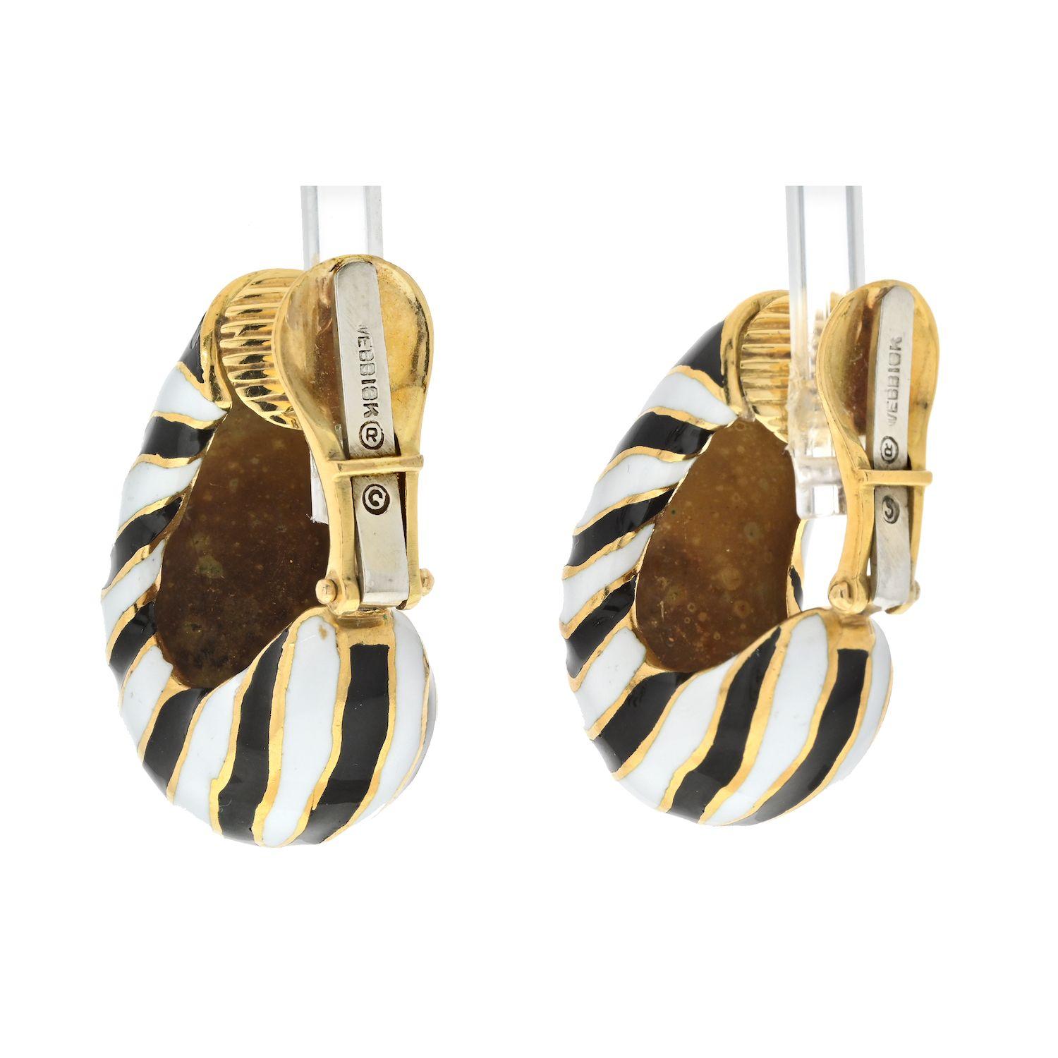 A stunning pair of earrings that exude timeless elegance and artistic flair by David Webb. The Platinum & 18K Yellow Gold Classic Zebra Black And White Stripe Enamel Earrings are a striking blend of sophistication and playfulness. Crafted with