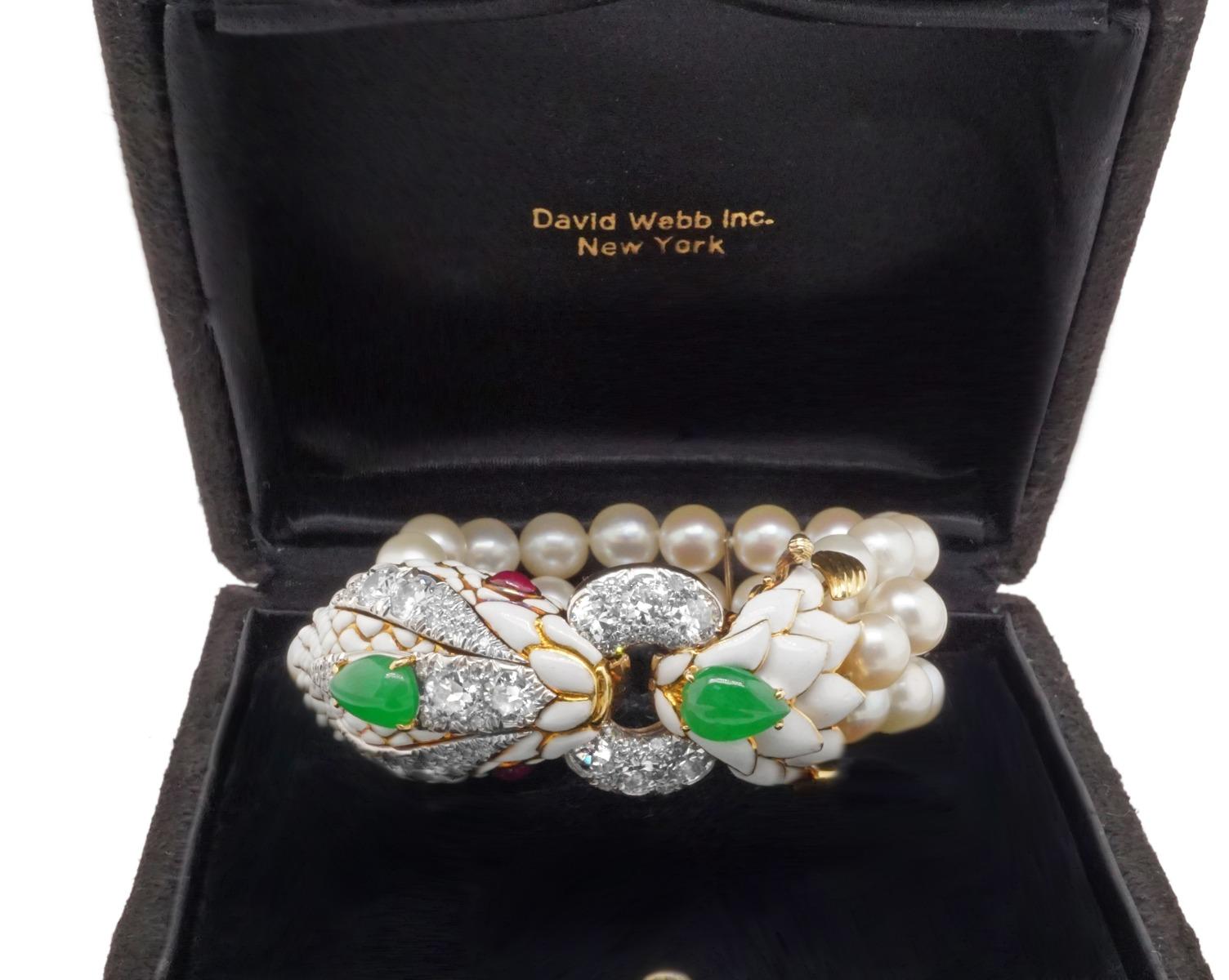 David Webb, diamond jade ruby pearl and white enamel bracelet.  Crafted in 18 karat gold and white enamel the serpents head features diamonds, jadeite jade, ruby eyes and 42 beautifully matched Akoya pearls 8.2-7.8 mm.  Dimensions, 7 1/2 