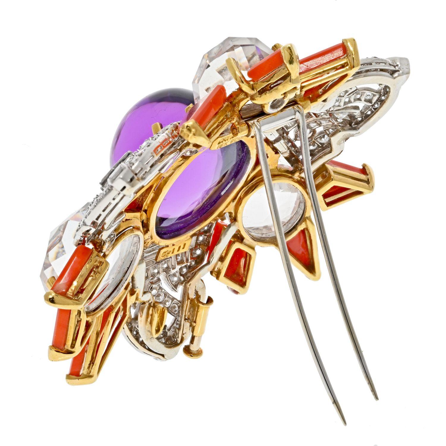 David Webb Platinum & 18K Yellow Gold Amethyst, Coral And Rock Crystal Star Brooch.

An exciting brooch by David Webb crafted in 18K yellow gold with diamonds set in platinum. Centering a cabochon oval cut amethyst, three checkerboard cut rock