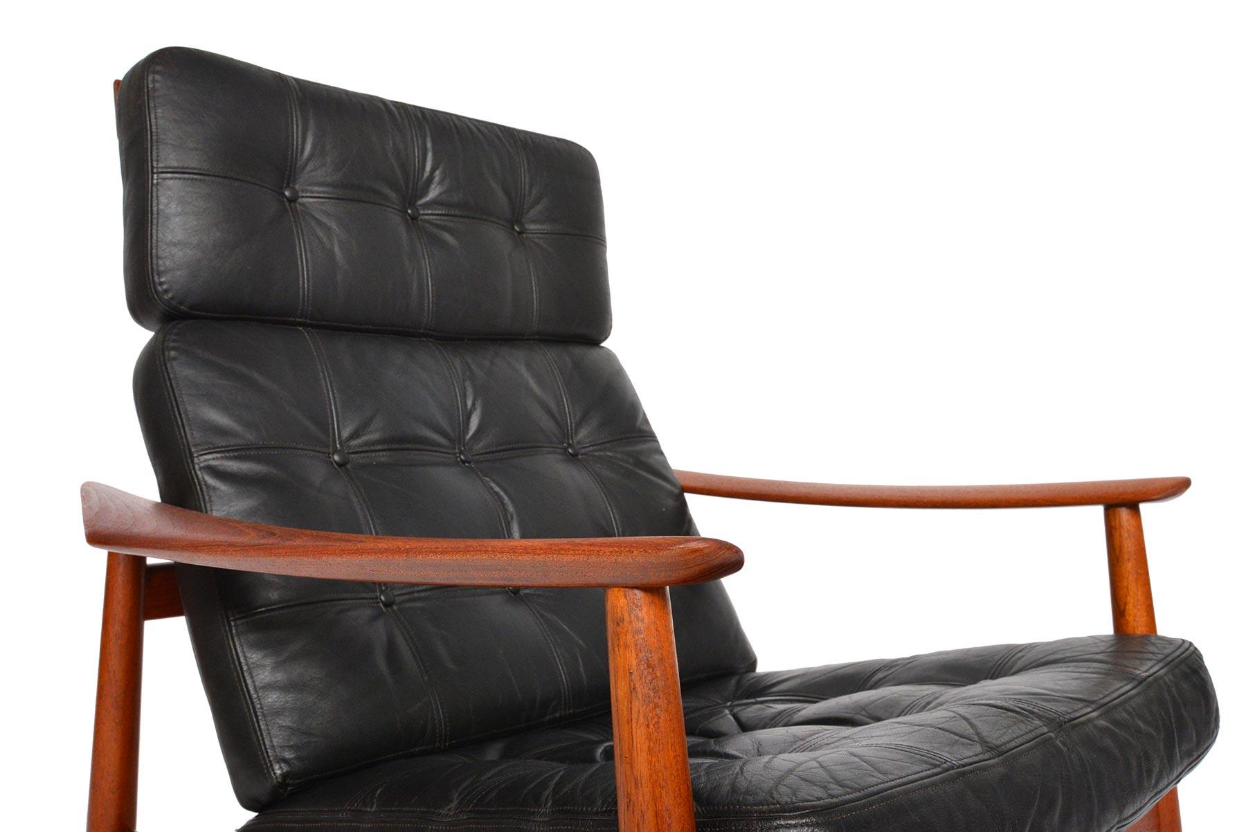 This stately Danish modern reclining high back lounge chairs was designed by Arne Vodder as Model 164 for France + Son in the 1960s. Beautiful bent teak gives ergonomic structure to the backrest. Large sculpted armrests gentle cant inward creating a