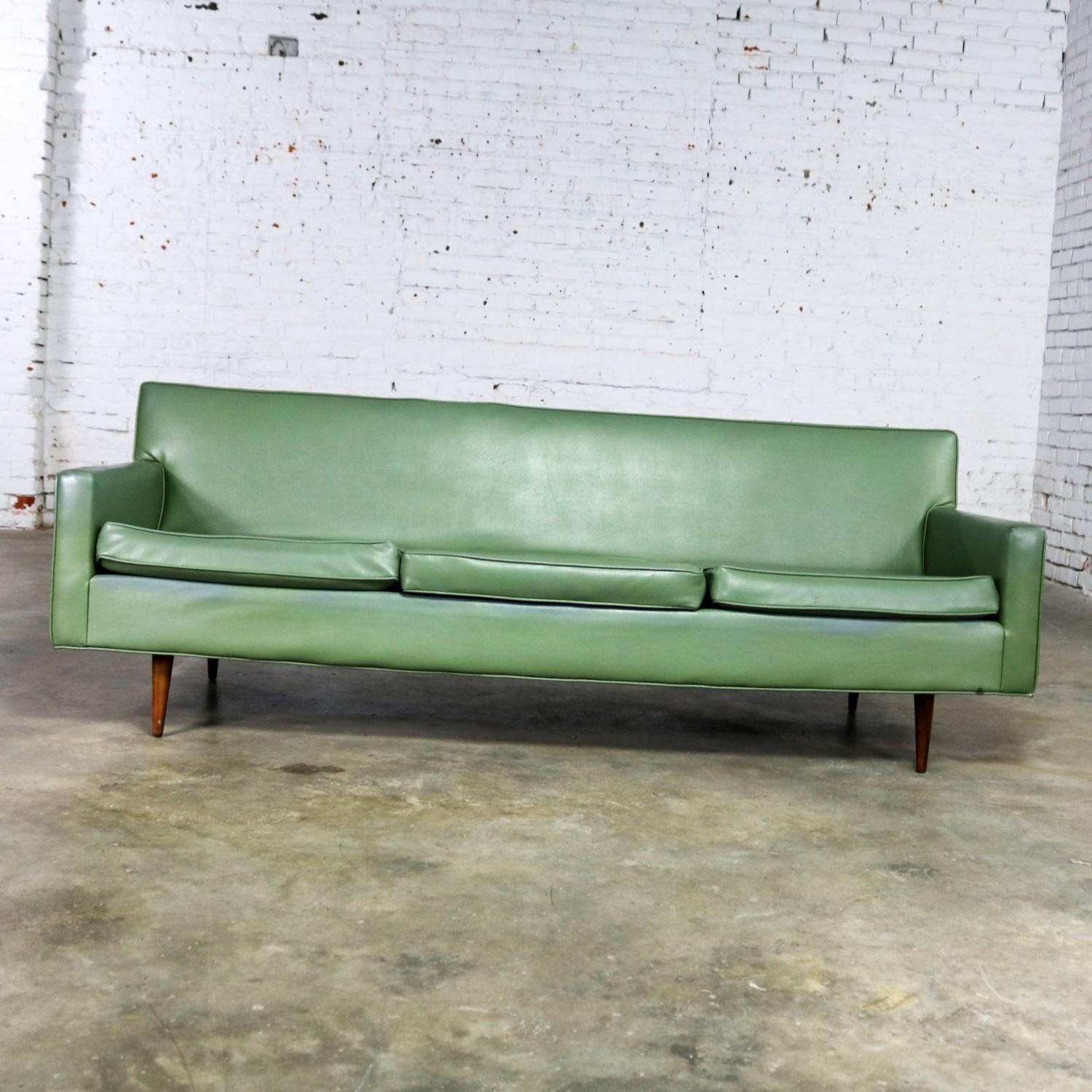 Handsome Mid-Century Modern vinyl sofa by Milo Baughman for Thayer Coggin. This slim and modern sofa frame is in wonderful condition. However, the vinyl upholstery leaves a little to be desired. But it will look fabulous when redone. It retains its