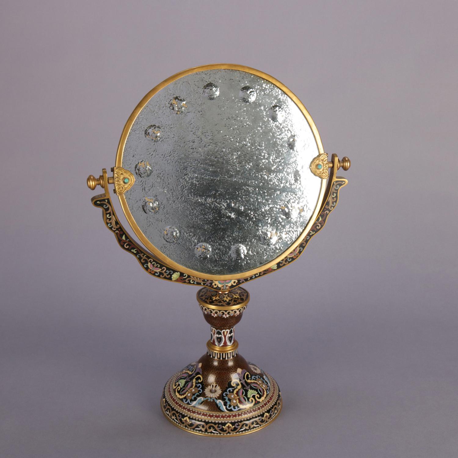 Antique Chinese vanity mirror features cloisonné enameled base with scroll, foliate and floral decoration, mirror with etched bamboo and cherry blossom decoration, 19th century

Measures: 18.25