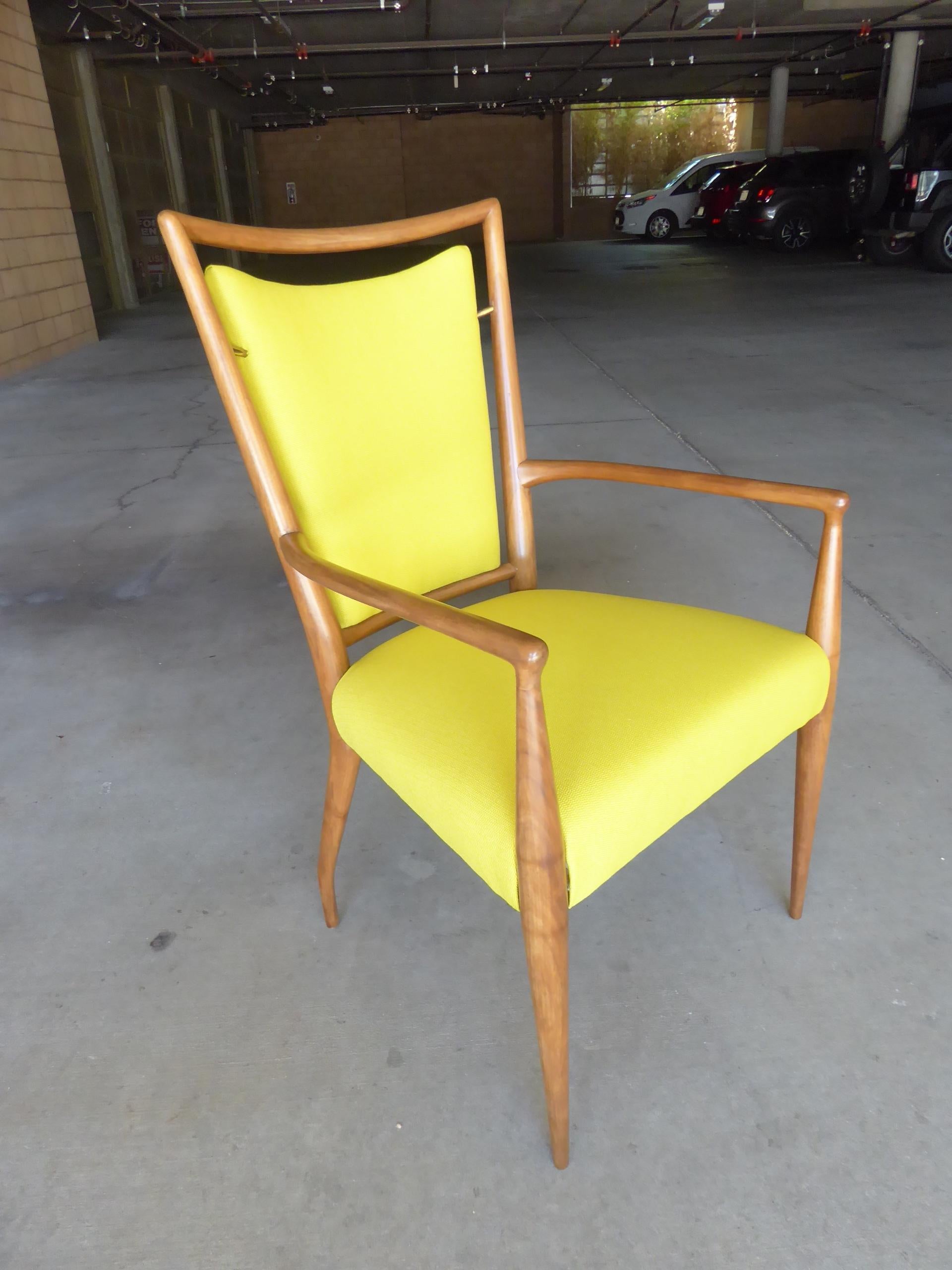 A bleached walnut armchair designed by J. Stuart Clingman for Widdicomb Furniture in the 1950s. The chair back is supported by brass hardware that holds it in place. Newly reupholstered.
