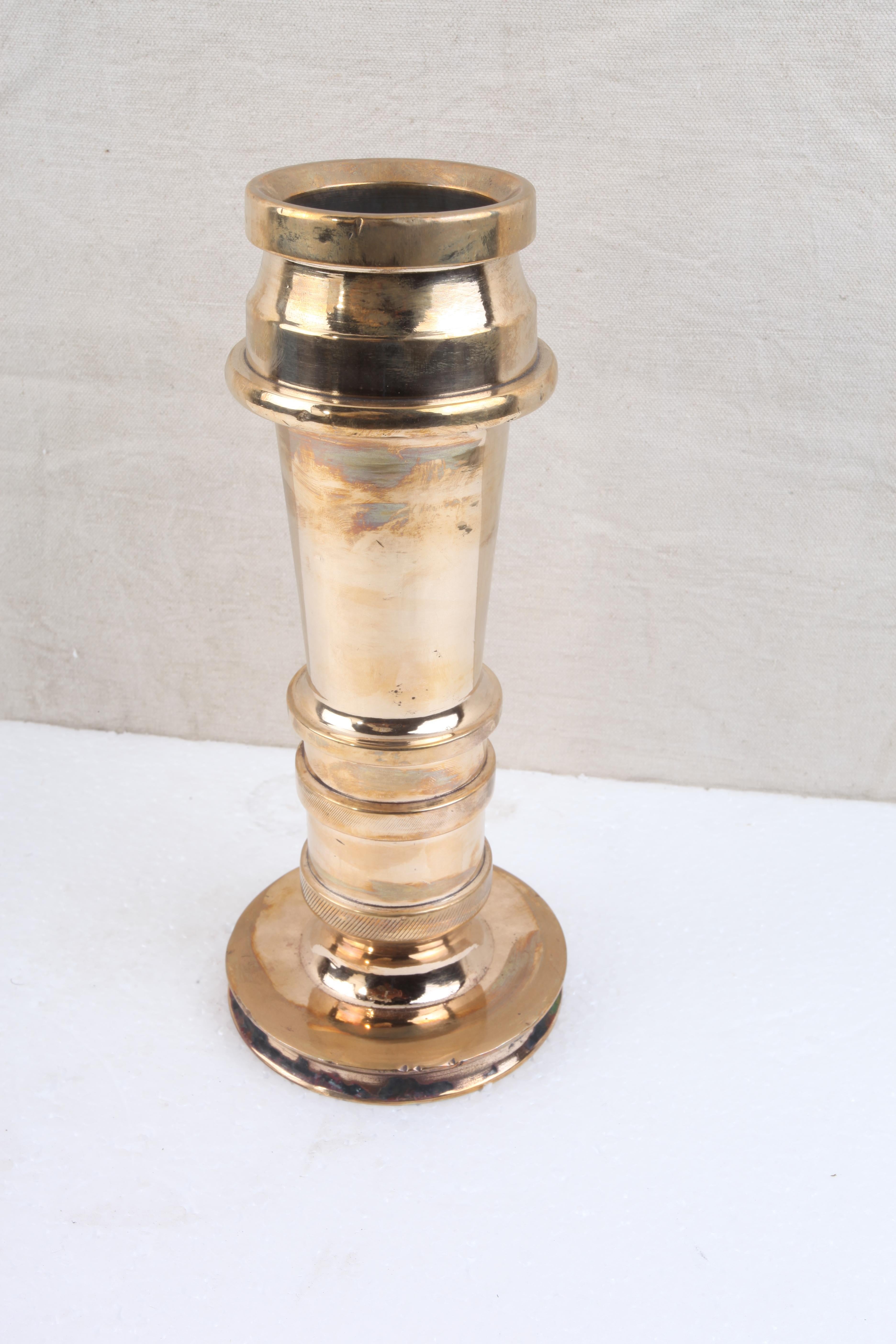 Now here's an unusual re-purposing. Solid brass fire-hose nozzles that have been converted to candle-stands or flower vases. I had the holes closed up so that they could hold water. Incredibly solid weight in cast brass at 8 pounds each. Groove