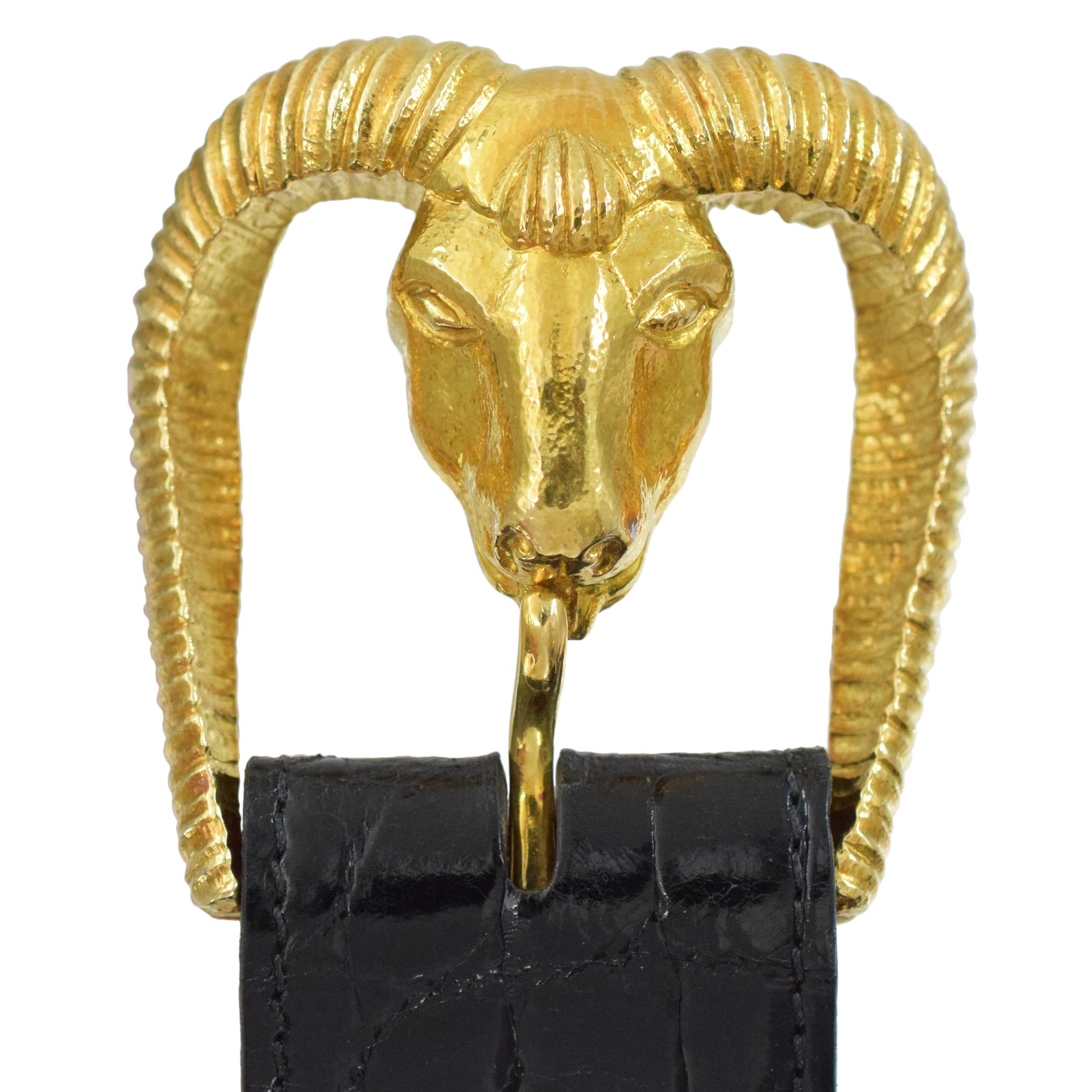 David Webb Ram Belt Buckle in 18k yellow gold. Accompanied by black genuine alligator leather belt, size 39.5.
Features head of the ram belt buckle and hammered gold finish belt loop. Buckle and the loop both inscribed Webb, 18k.The buckle measures