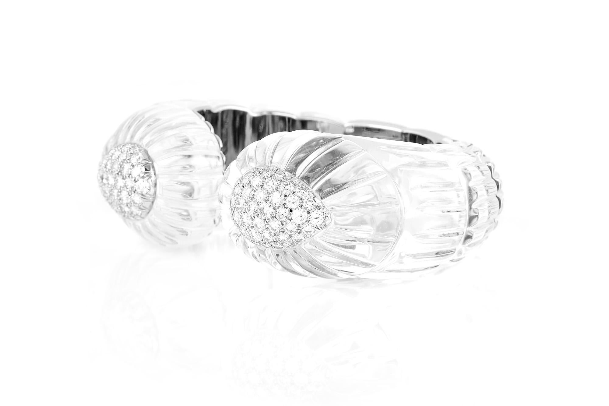 David Webb crystal cuff bracelet, finely crafted in 18 k white gold and platinum, featuring carved rock crystal and brilliant-cut diamonds, weighing approximately 5.90 carat.