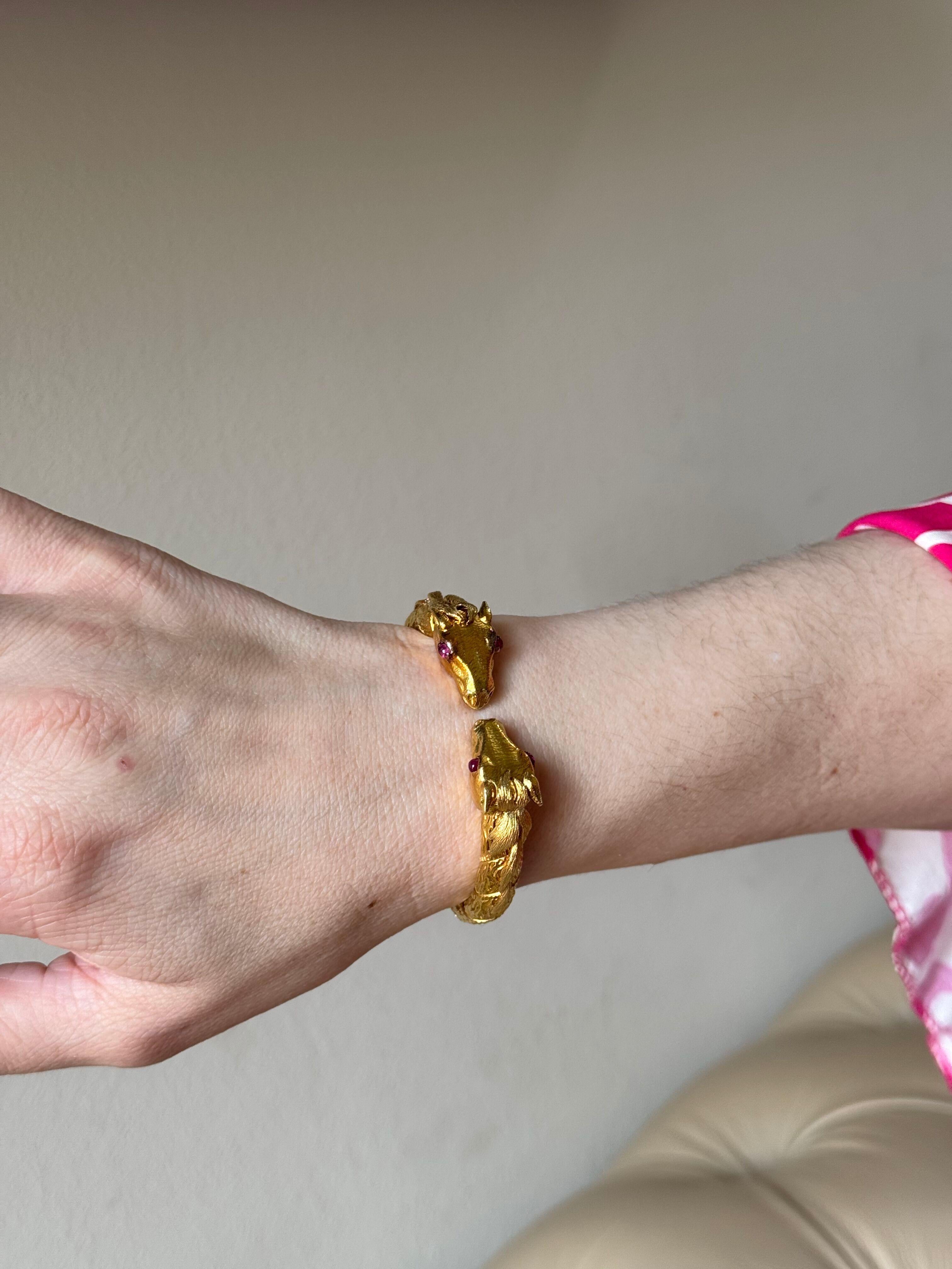 An 18k yellow gold bangle bracelet by David Webb, depicting two antelope heads, with ruby cabochon eyes.
Bracelet will comfortably fit an approx. 6.5