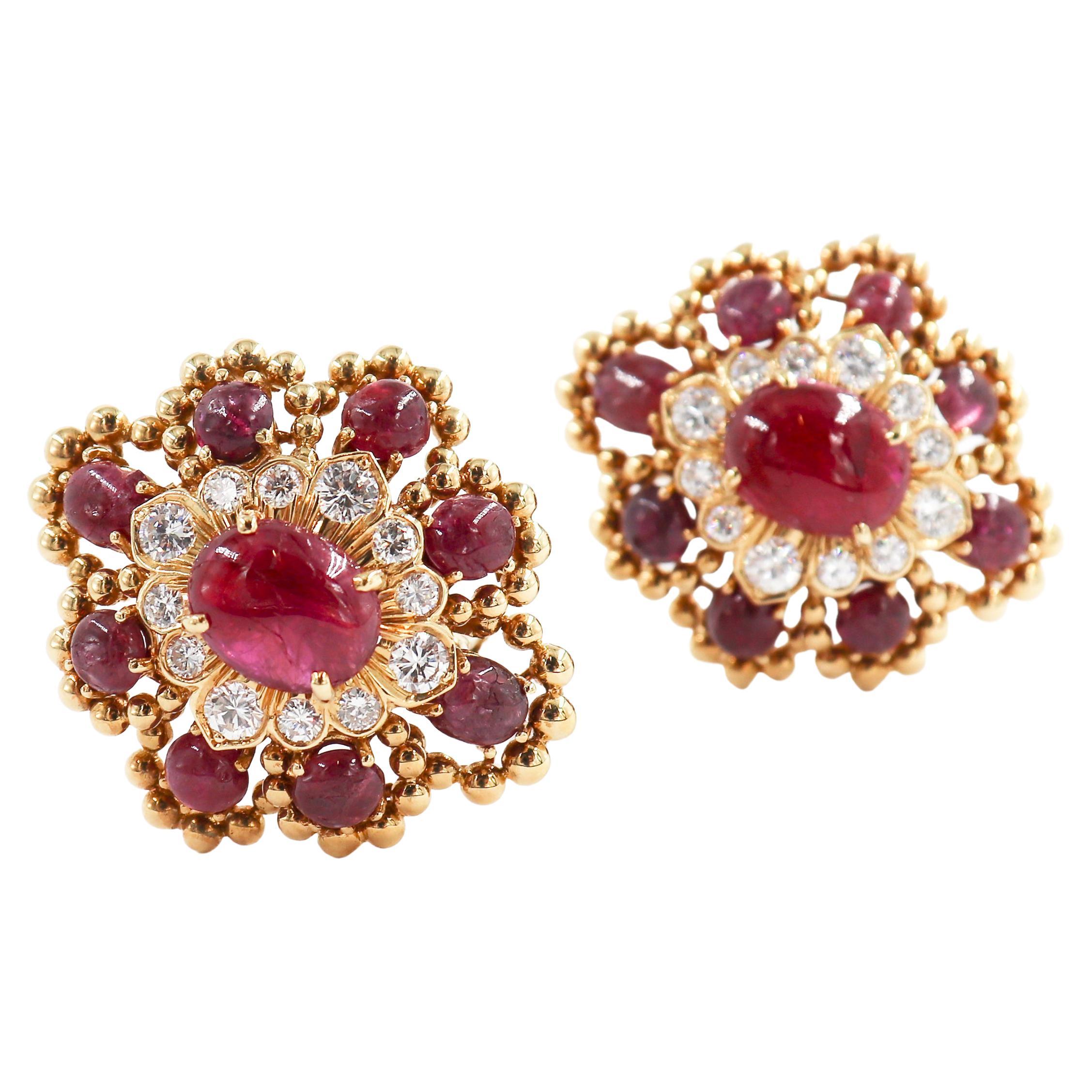 Those spectacular late 60's, early 70's David Webb clip-on Earrings crafted in 18 karat Yellow Gold, feature 9 cabochon rubies and 12 round brilliant diamonds each. 

They are each stamped 'David Webb' and '18K'.

Type: Ruby and diamond