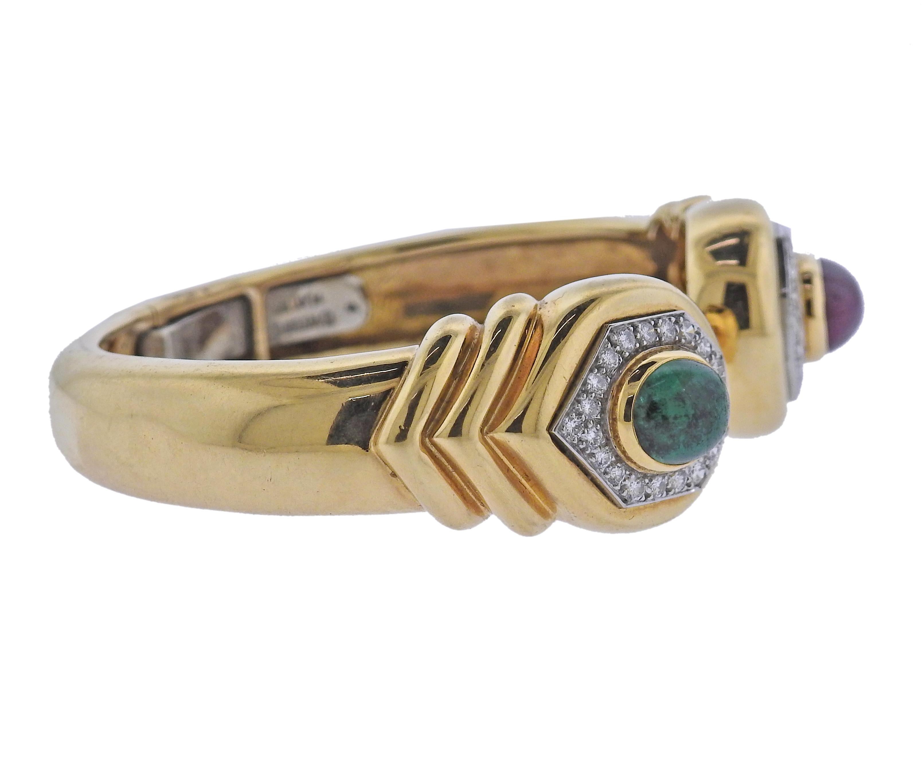 18k gold and platinum cuff bracelet by David Webb, decorated with approx. 1.20ctw in diamonds and 10.6mm x 8.4mm ruby and emerald cabochons. Bracelet will fit up to 7
