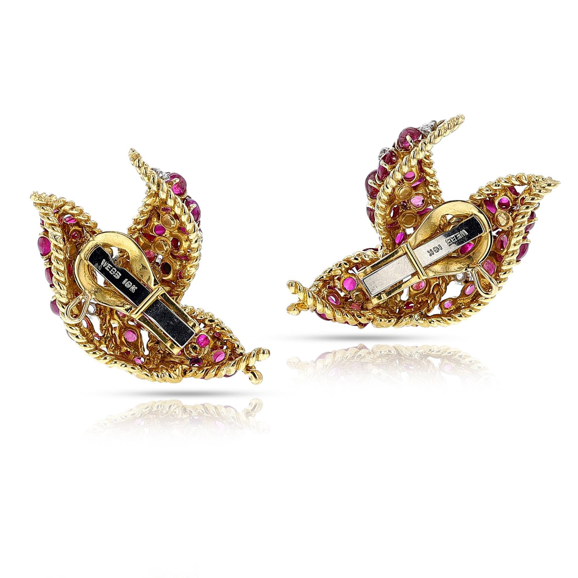 A pair of David Webb Ruby Cabochon and Diamond Earrings made in 18k yellow gold. The total weight of the rubies cabochons are 24 carats. The total weight of the diamonds is 0.76 carats. The total weight of the earrings is 22.08 grams. The dimensions