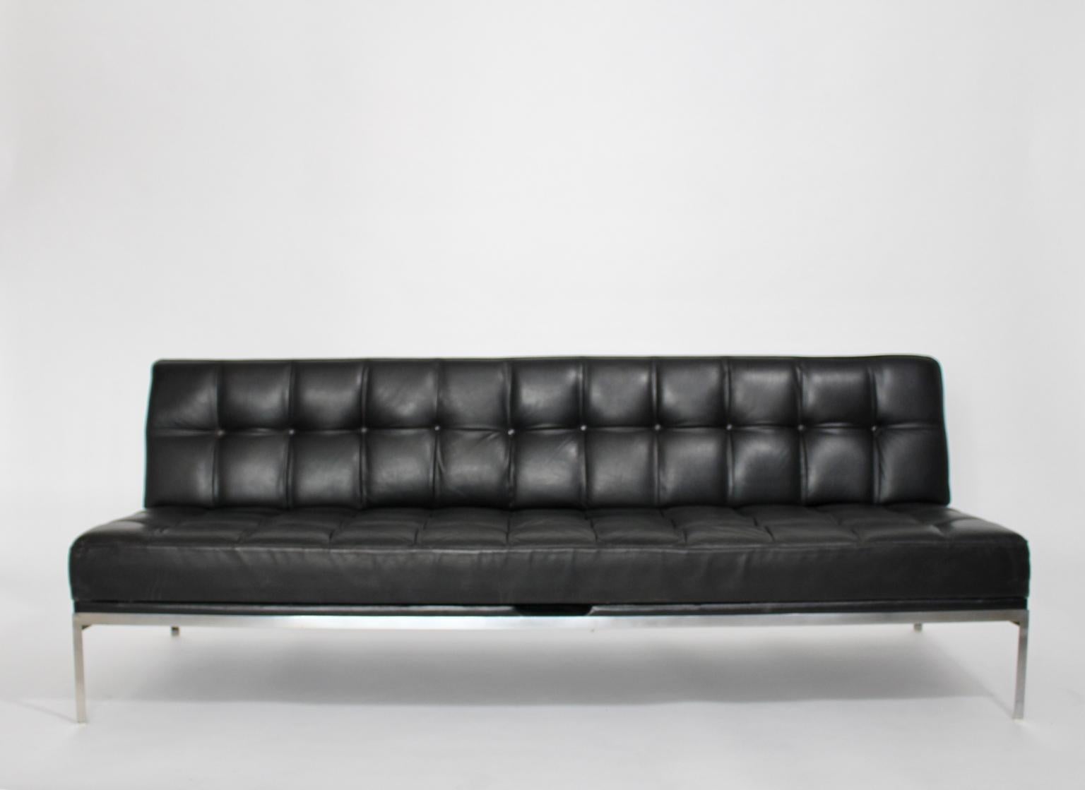 Mid Century Modern vintage sofa or daybed model Constanze from black quilted leather with chromed metal feet designed by Johannes Spalt 1961 for Wittmann, Austria. 
Easy to handle by one hand to make the change from sofa to daybed. 
Iconic statement