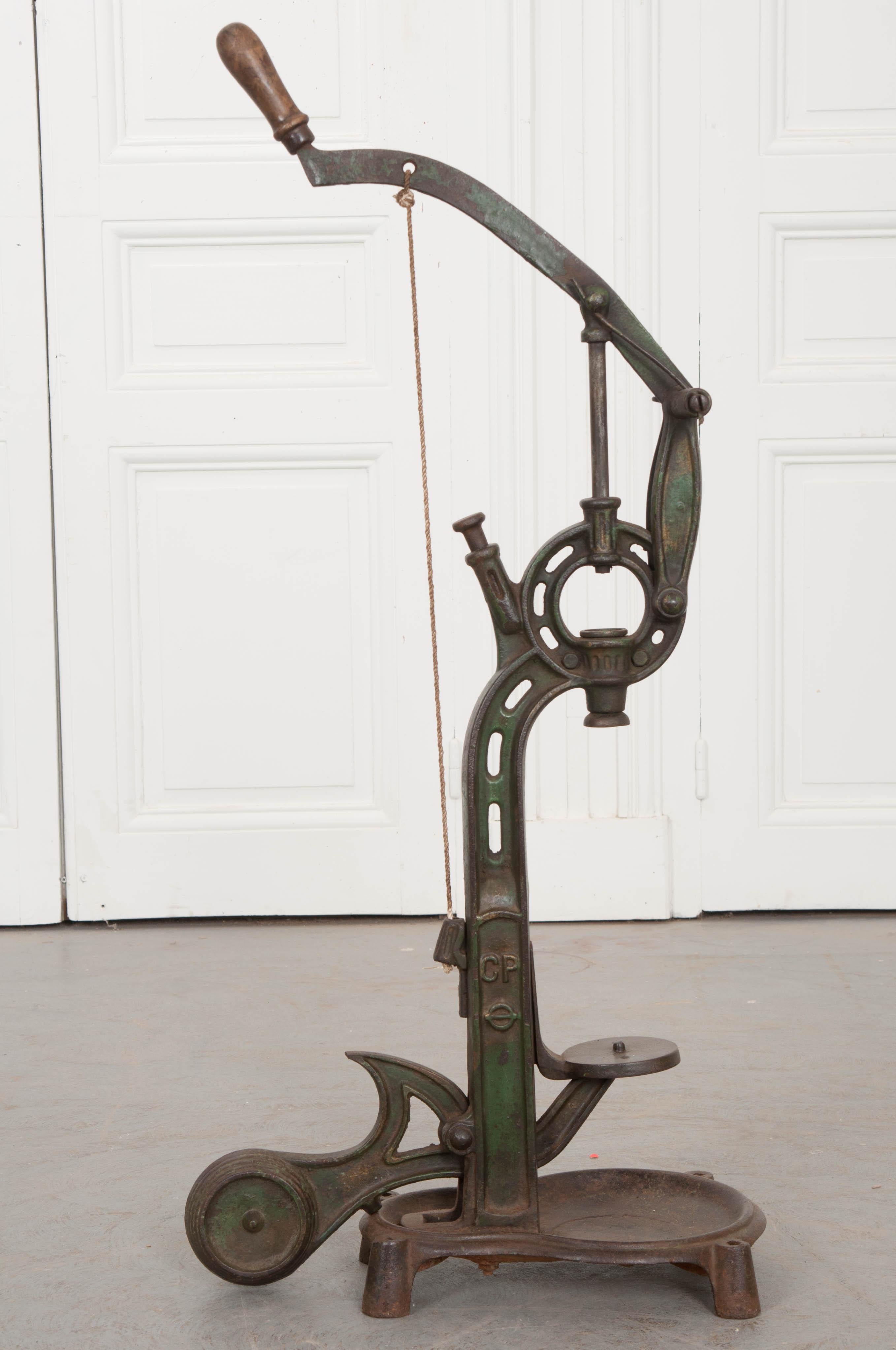 This wine corker, made, circa 1870, was used in a winery in France. This corker was painted green at one point in its lifetime, however time has erased much of the paint, leaving only a memory of what it once was. Wine production is intrinsic to