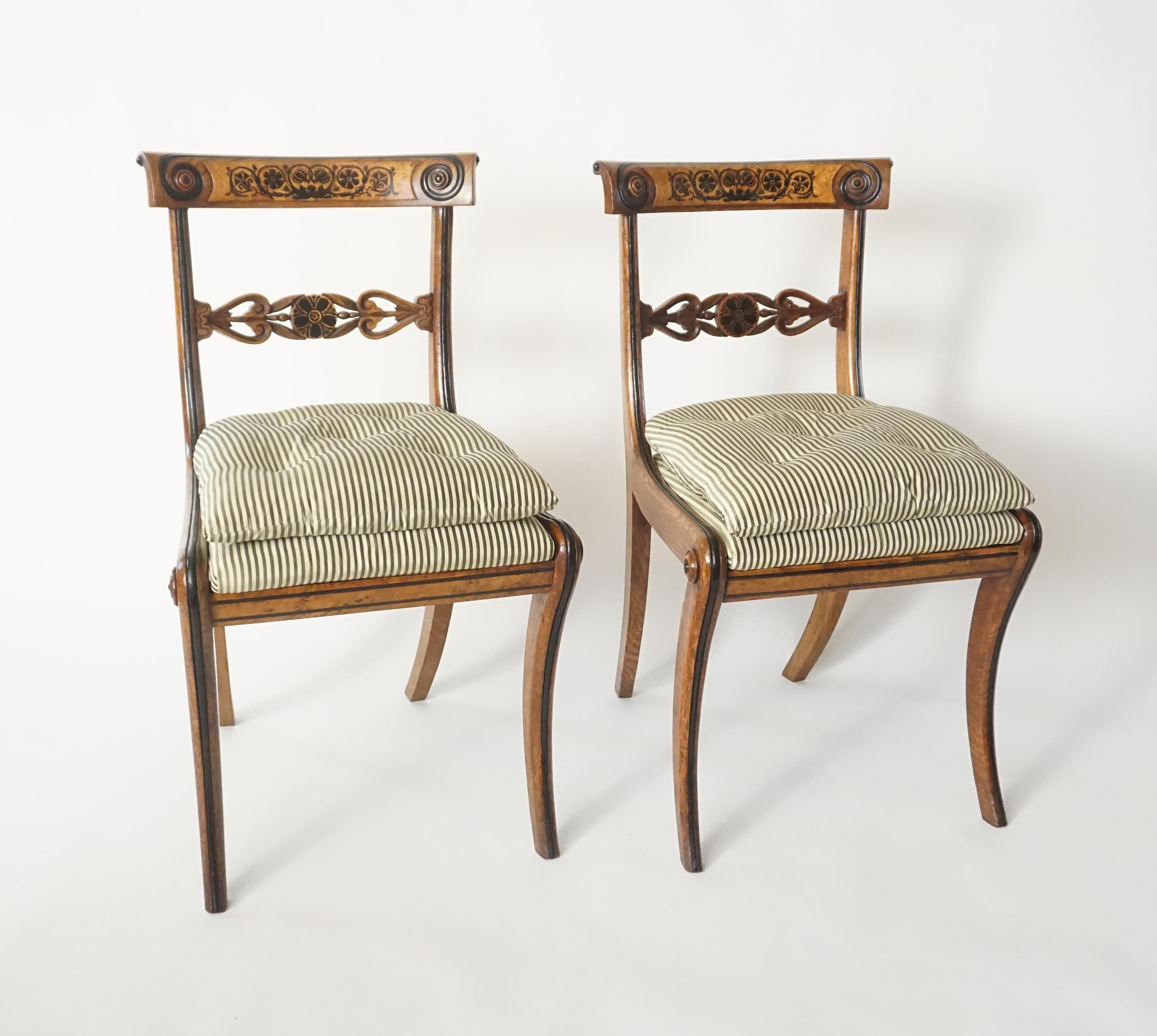 A rare and important set of four side or dining chairs by famed and short-lived English Regency-period cabinet-maker and sculptor George Bullock (c. 1782 - 1818) of klismos form; the pollard oak frames having foliate inlays of ebony with burled
