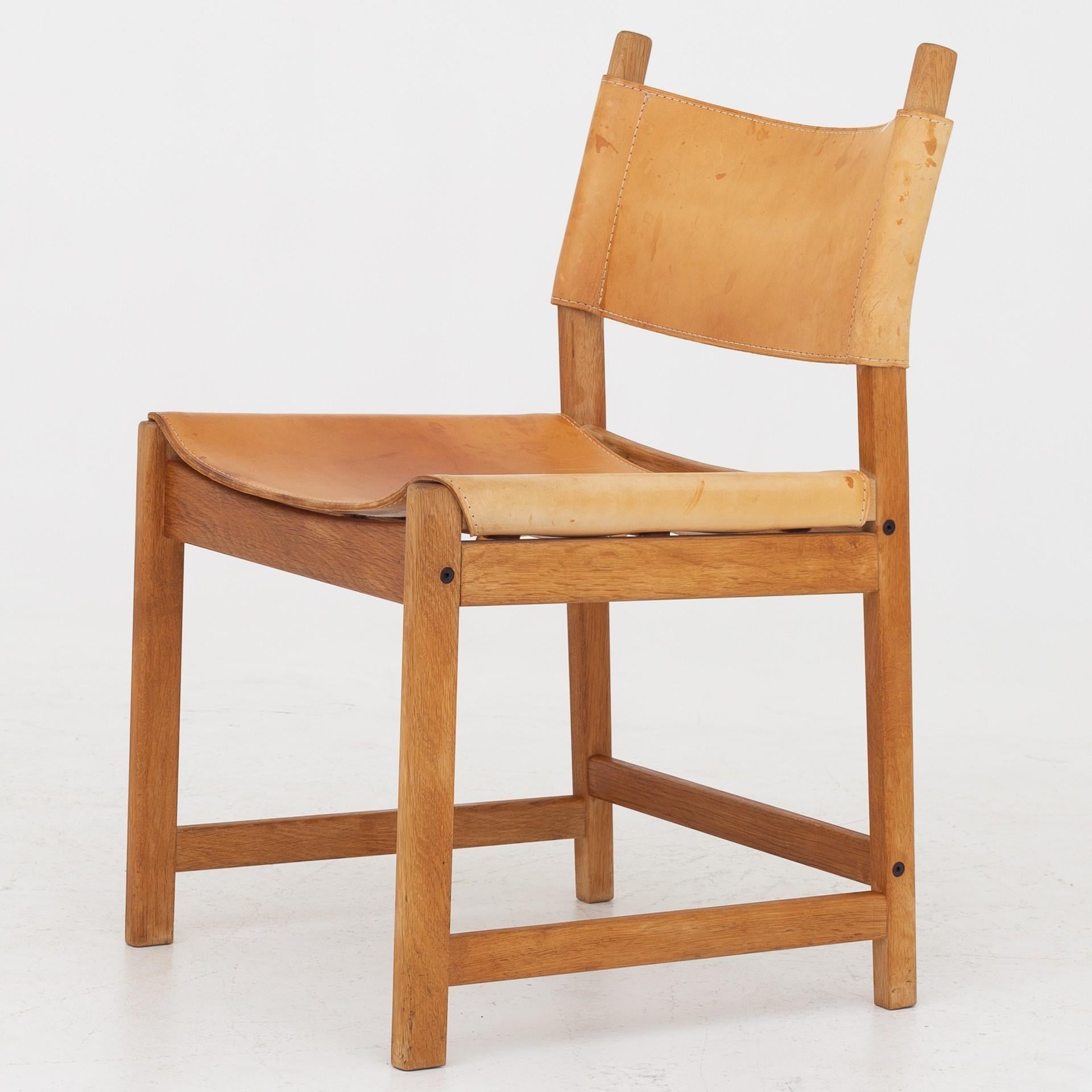Six dining chairs in oak and patinated natural leather. Maker KP Møbler.